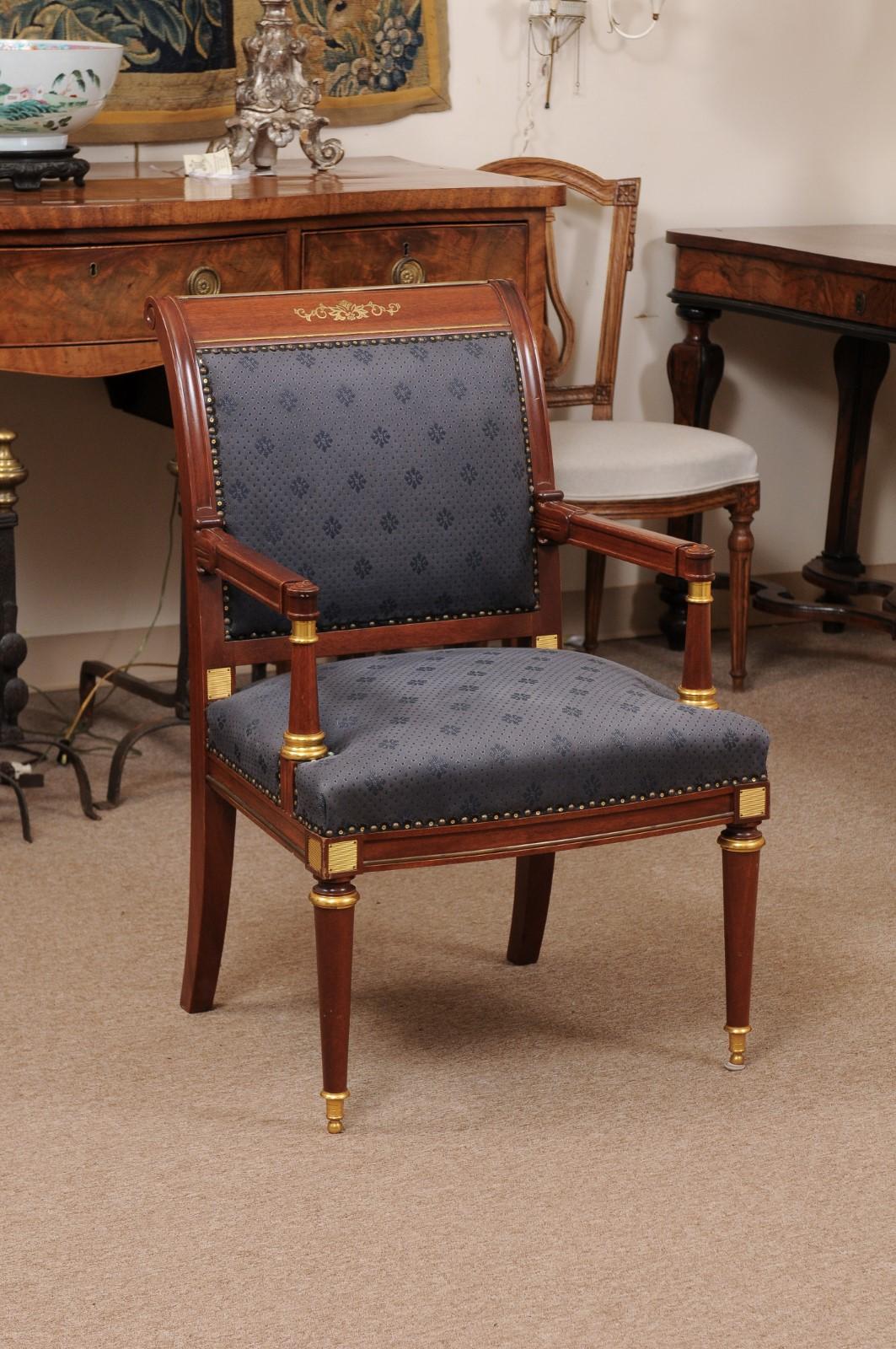 Neoclassical style mahogany open arm chair/fauteuil with ormolu mounts, rounded tapering legs, and navy blue upholstery, 20th century.
