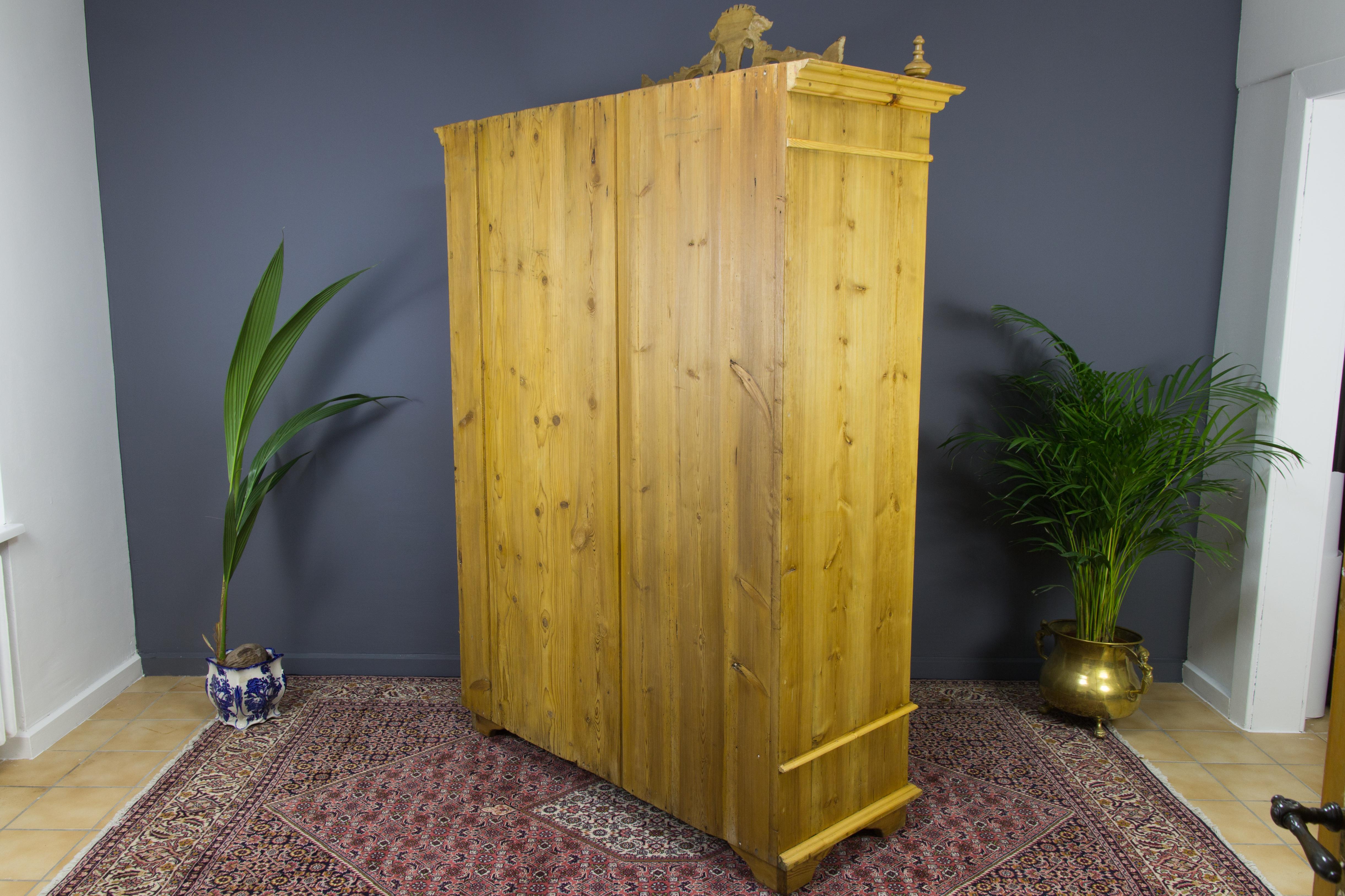 Latvian Baltic Pine Two-Door Armoire with Carved Flower Crown, 1920s