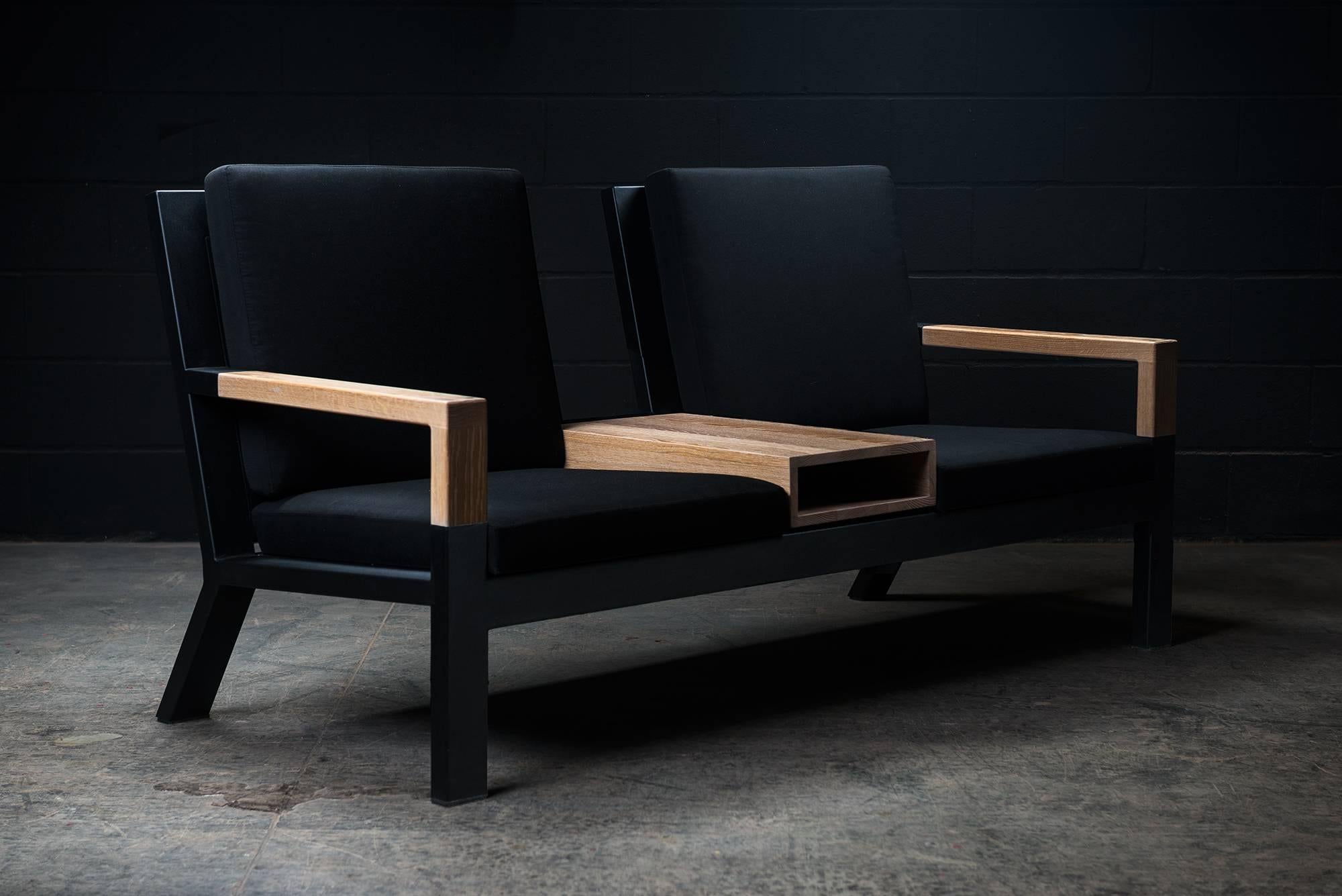 The Baltimore modern armchair duo or loveseat is handmade to order from our unique Ambrozia black textured steel tubing frame design with a backchair in solid wood slats and wooden arms. Stainproof and UV resistant upholstestry in Sunbrella fabrics.