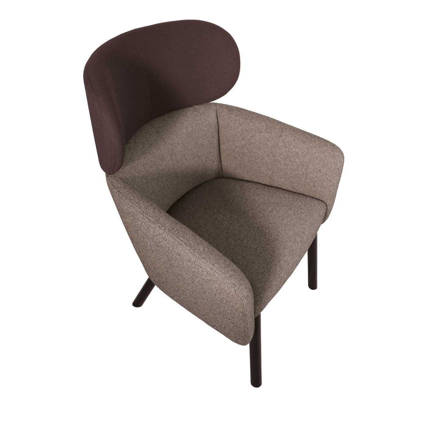 A stunning accent in a classic and modern living room, this exquisite armchair features a robust beechwood structure with short slanted legs, and a large and welcoming seat comprising armrests and a tall backrest. The seat, back, and armrests are