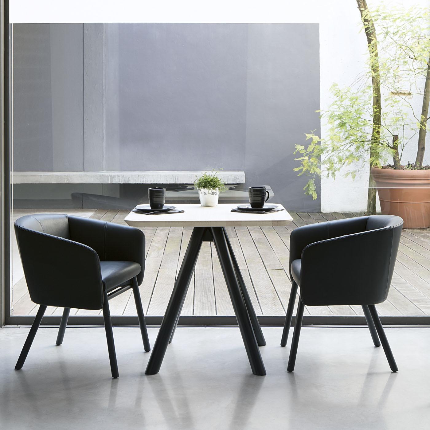 Infusing a modern living room or dining room with plush sophistication, this elegant chair combines a slim supporting structure with a large, enveloping seat, exuding a comfortable and dynamic profile at the same time. It comprises a beechwood