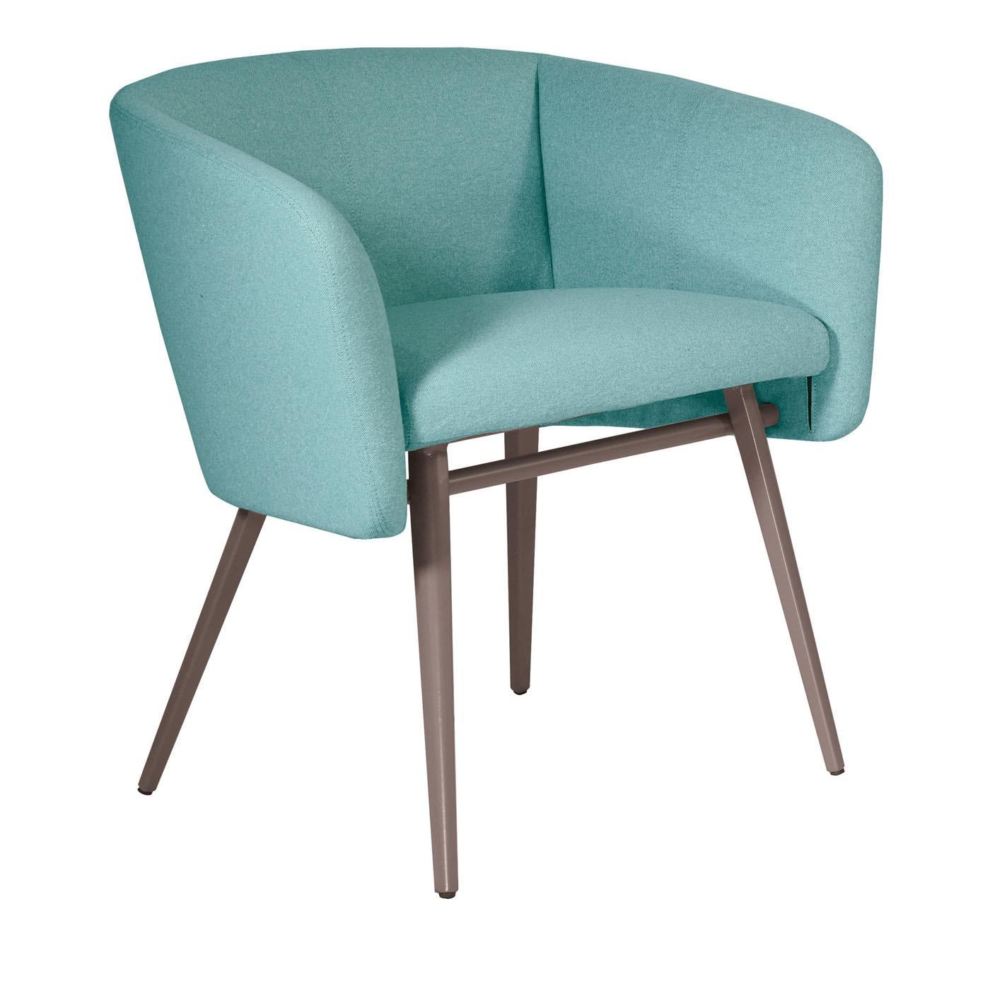 Inspired by the welcoming and comfortable design of the traditional tub chair, this piece features a gray-lacquered structure in beechwood with tall and slanted legs. A light blue fabric upholsters the seat, back, and armrests that are padded with