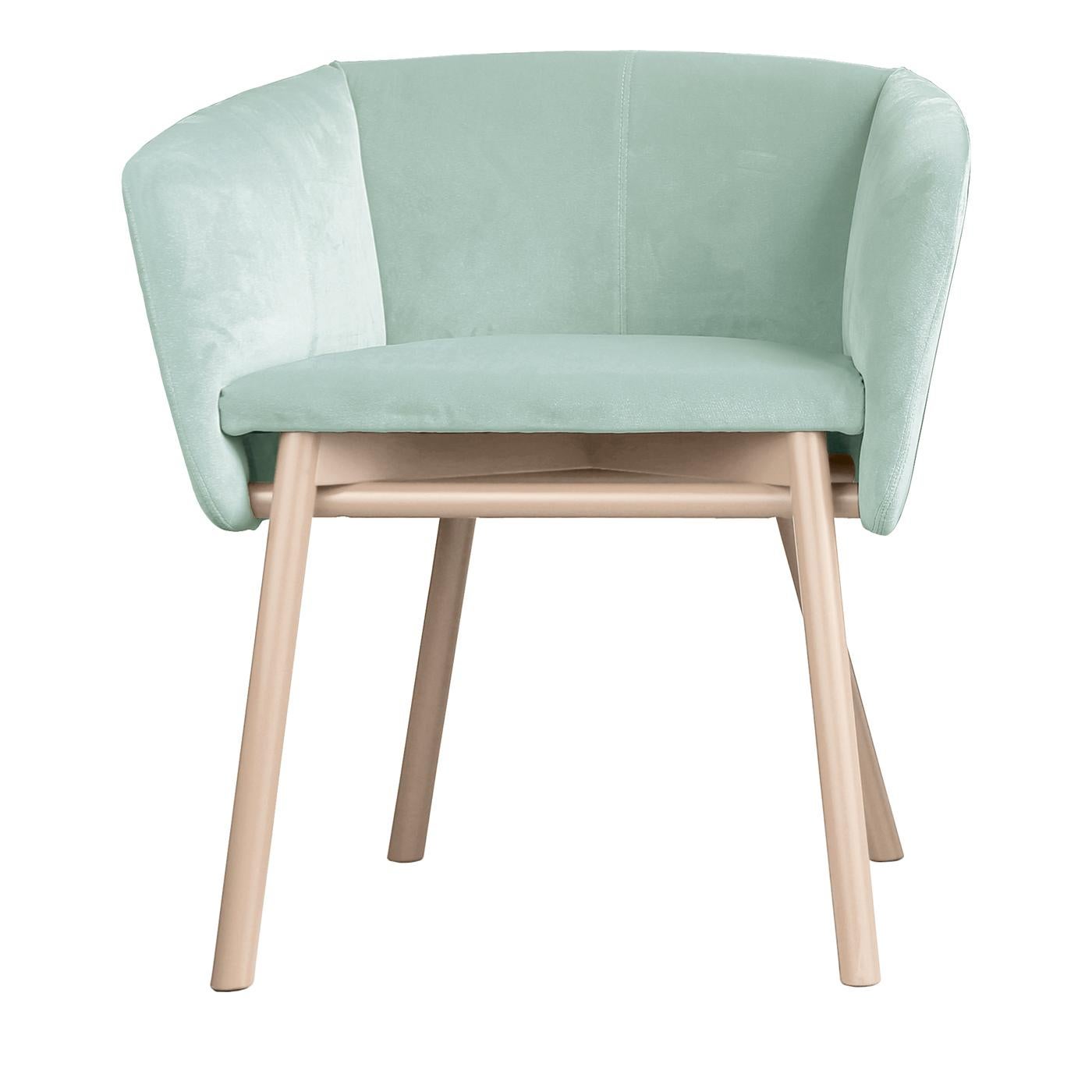 Refined and comfortable, this elegant armchair features an interlocking structure in bleached beechwood with slanted legs, and a sumptuous seat in a pale green delicate hue, with enveloping arms and backseat reminiscent of the traditional tub chair.