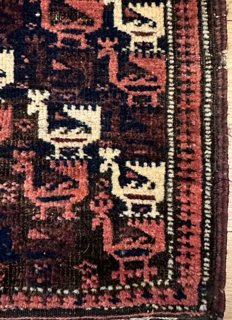 Baluch bird bag from Persia

Age: circa 1870

Size: 2′.4″x1′.3″ (71×38 cm) including the flatwoven back

The navy blue field shows diagonals of stylized small peacocks in ivory,aubergine and red.Usually the birds are larger and centered by an ivory