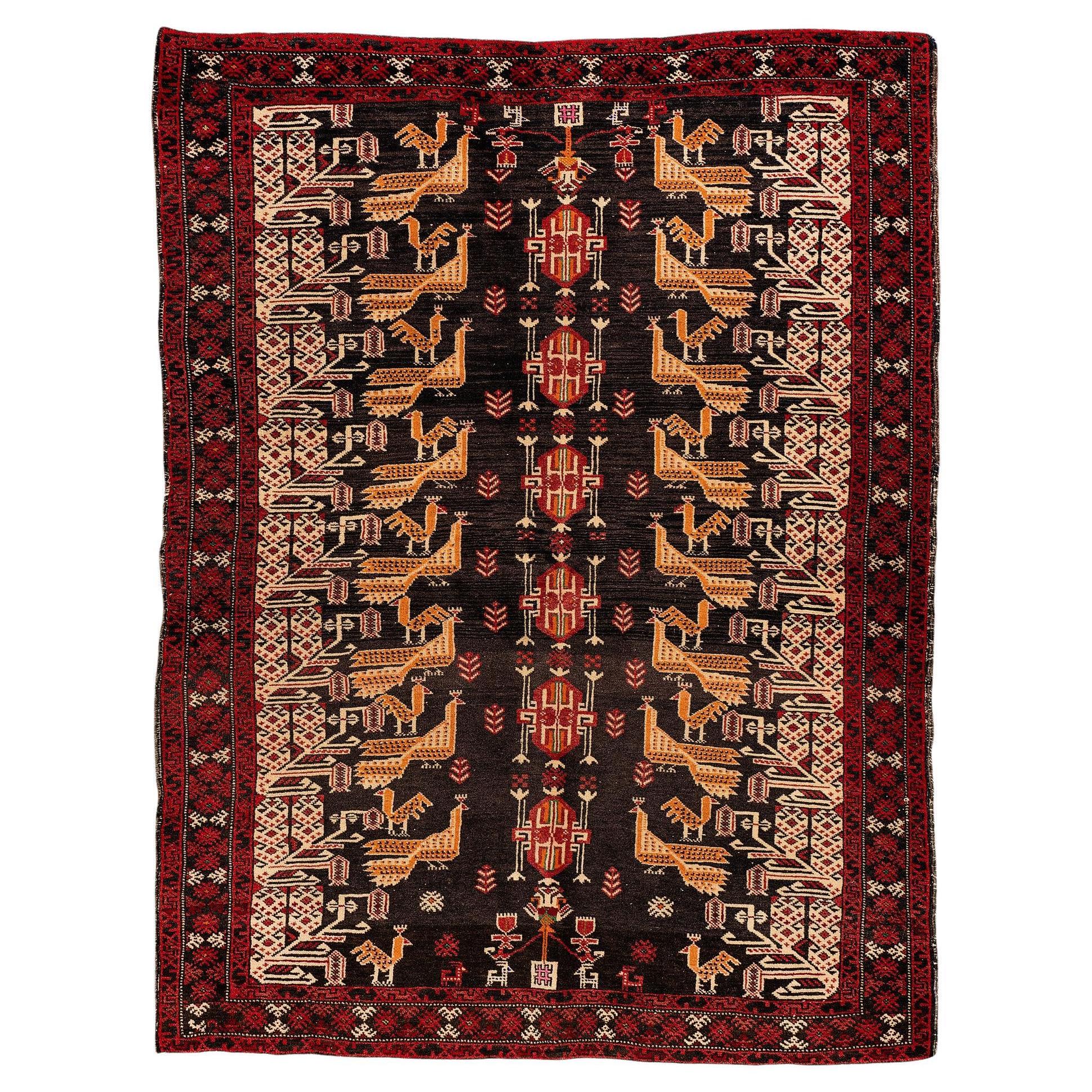 Baluche - East Persia

This is a beautiful Persian Baluche rug handmade in the 1950s. It has a black background and red borders. The main highlight is the two columns of yellow peacocks in the centre of the carpet and other geometric figures. It is