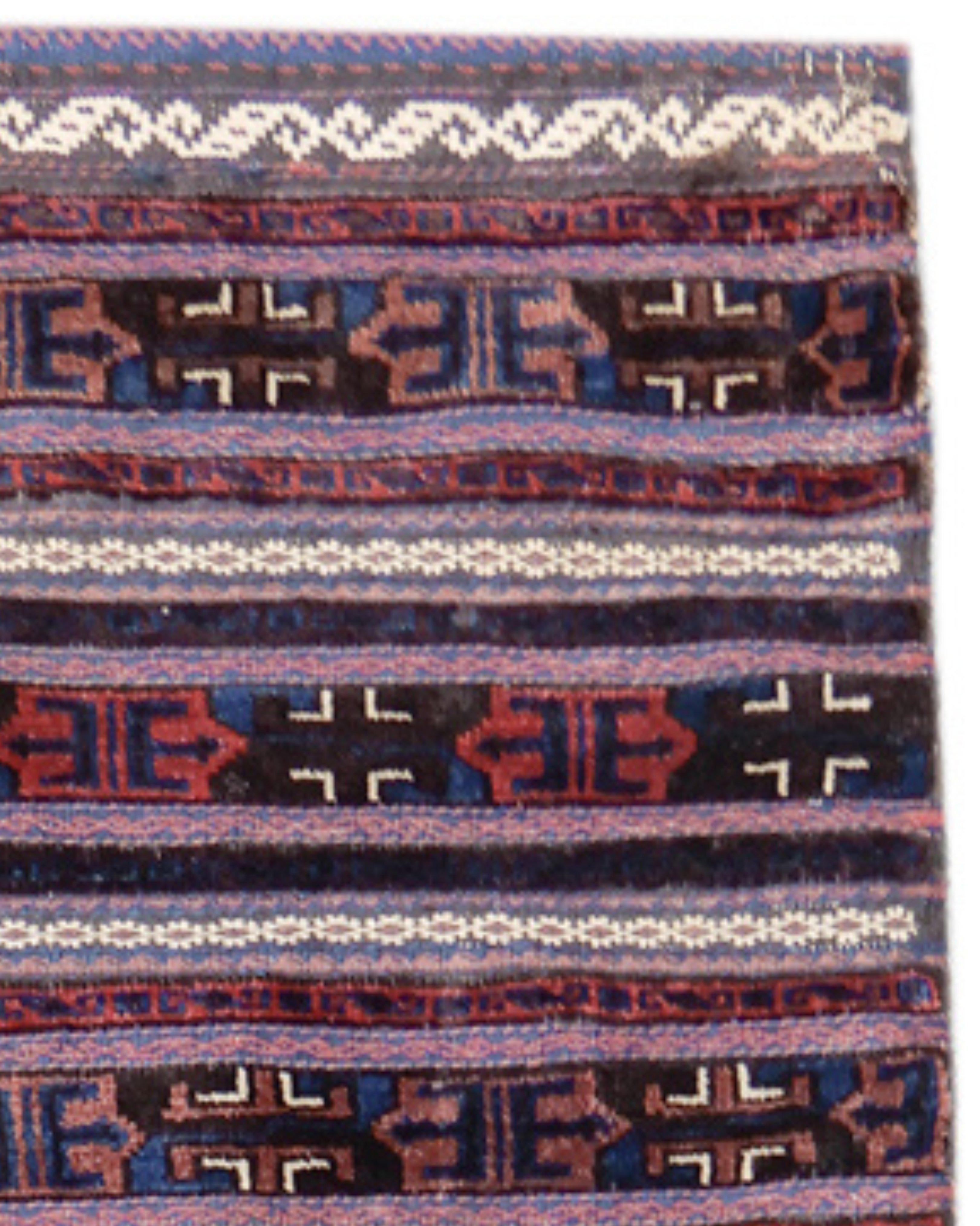 Baluch Khorjin Rug, Late 19th Century

Baluch pile weaving has been informed throughout its history by the traditions of neighboring groups. This complete double saddle bag set, or ‘khorjin,’ draws thin bands in alternating pile and flat weave in