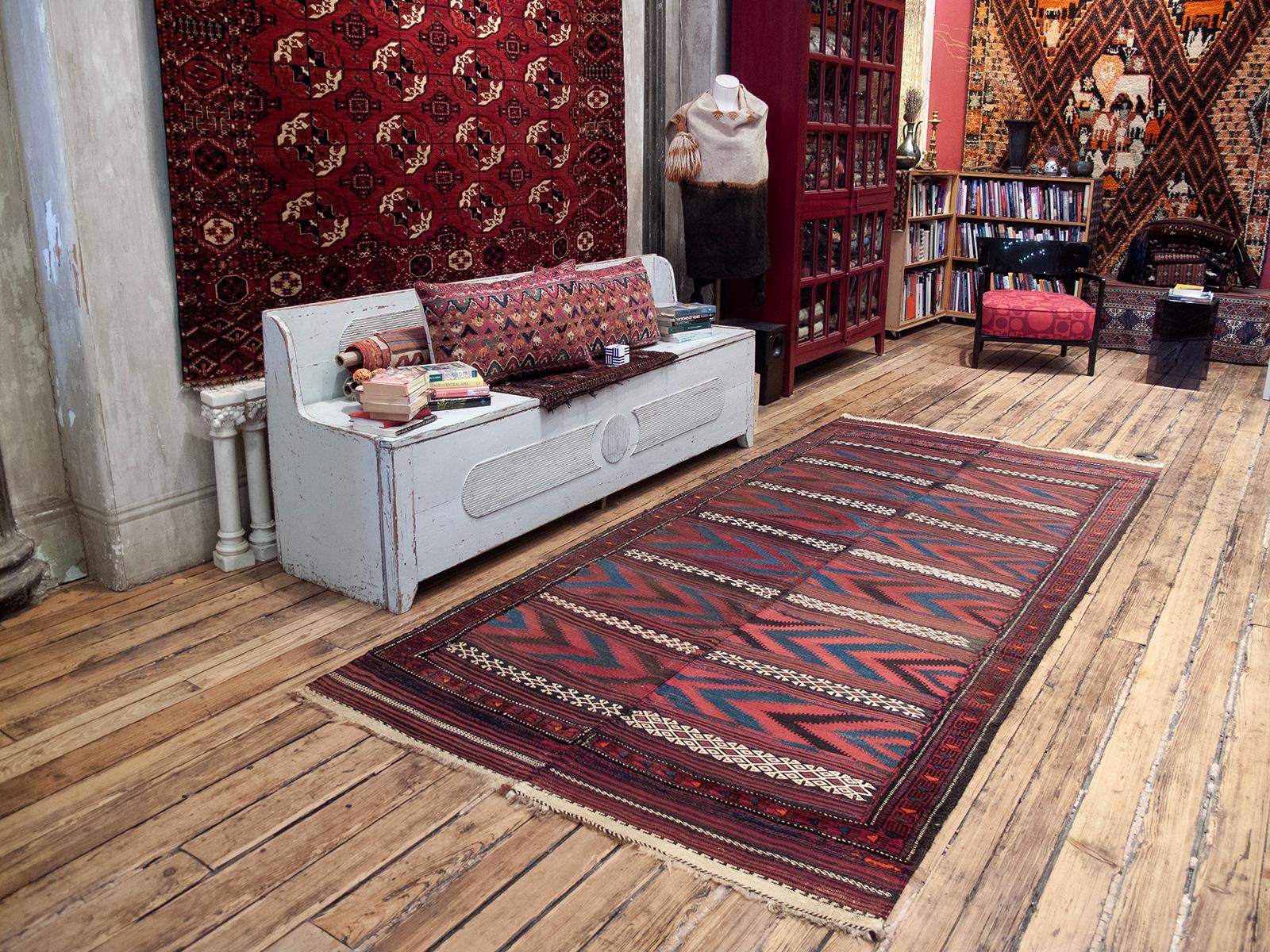 An old kilim, attributed to one of the Baluch tribal groups living along the western borders of Afghanistan who are all prolific weavers.

Woven in two halves on a simple nomadic loom, this kilim displays the characteristic color palette, design and