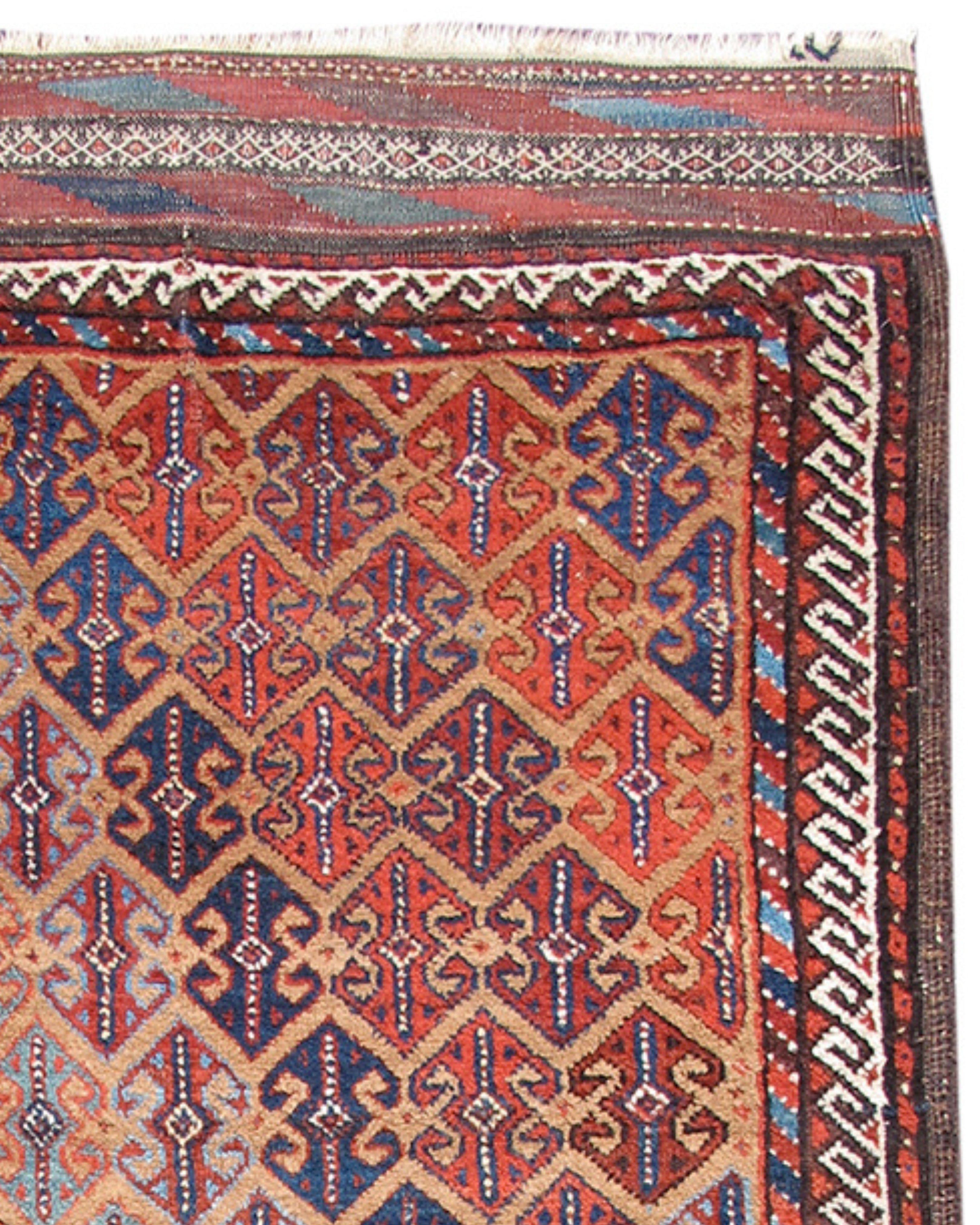 Antique PersianBaluch Rug, c. 1900

This vividly colored Baluch rug combines two very characteristically Baluchi themes that are very seldom seen in the same weaving: a camel ground with an all-over pattern of double-anchor ornament. Derived from
