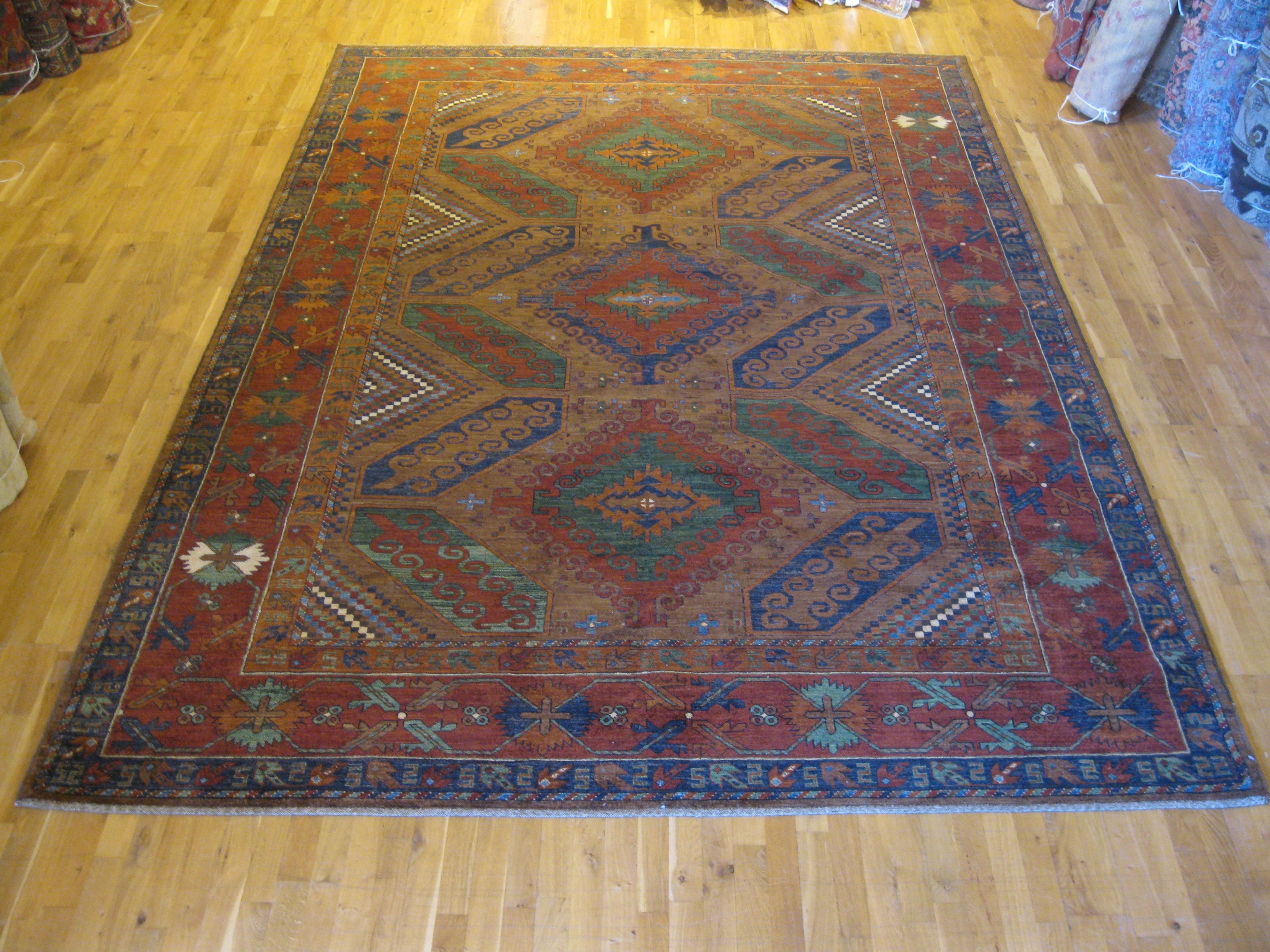 Baluchi carpets were originally made by Baluch nomads, living near the border between Iran, Pakistan and Afghanistan and were known for their lively designs. This contemporary example features the traditional red, brown and dark blue colors in an