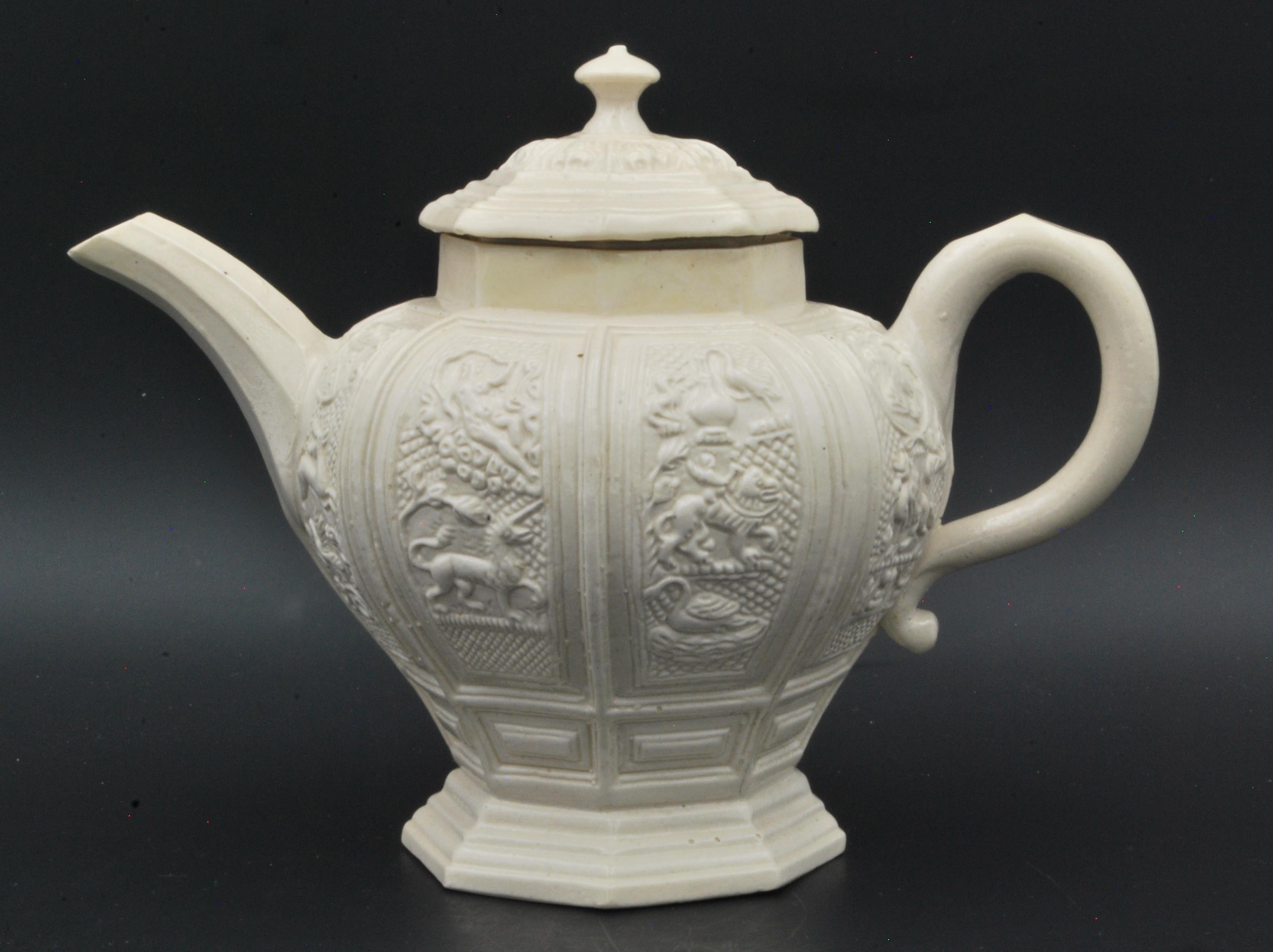 In salt-glazed stoneware, crisply moulded with fabulous beasts and birds.