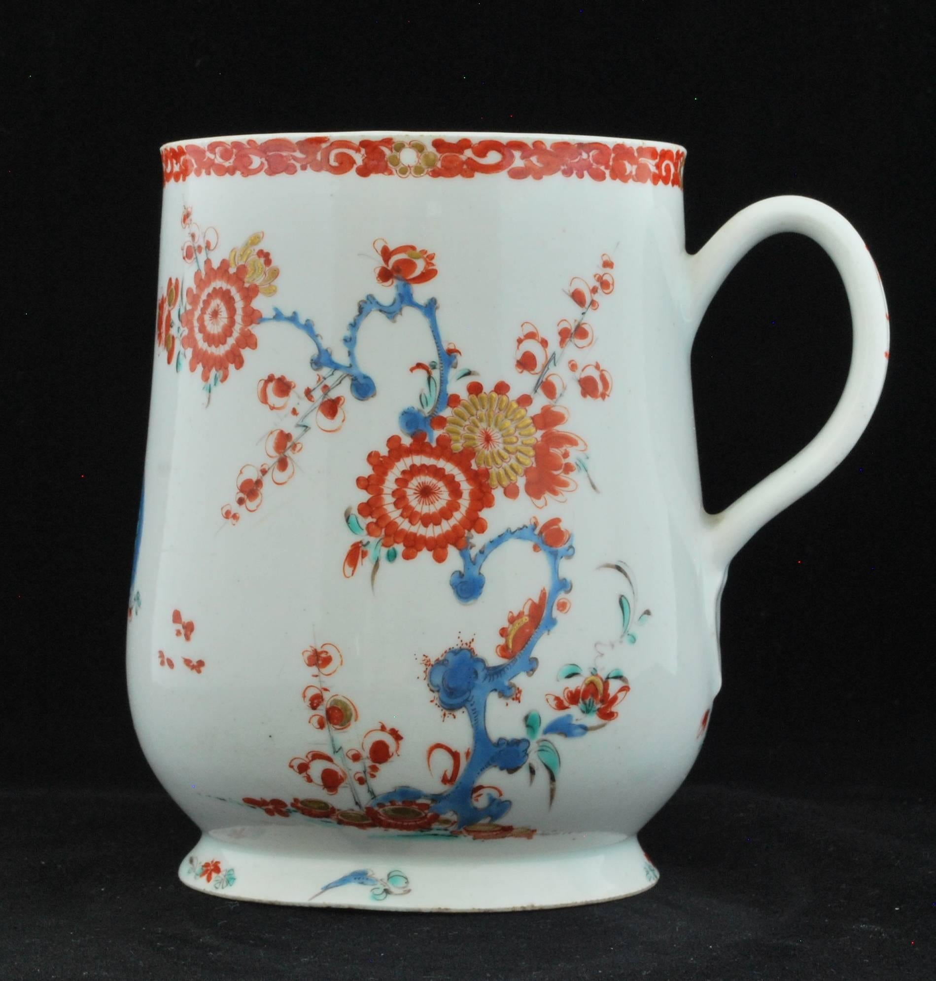 Pint mug of baluster form with flared base and grooved strap-handle with heart-shaped termination. The face of the mug painted after the Kakiemon with the two Quail pattern. The reverse painted with a kikyo bush and with scattered floral sprigs