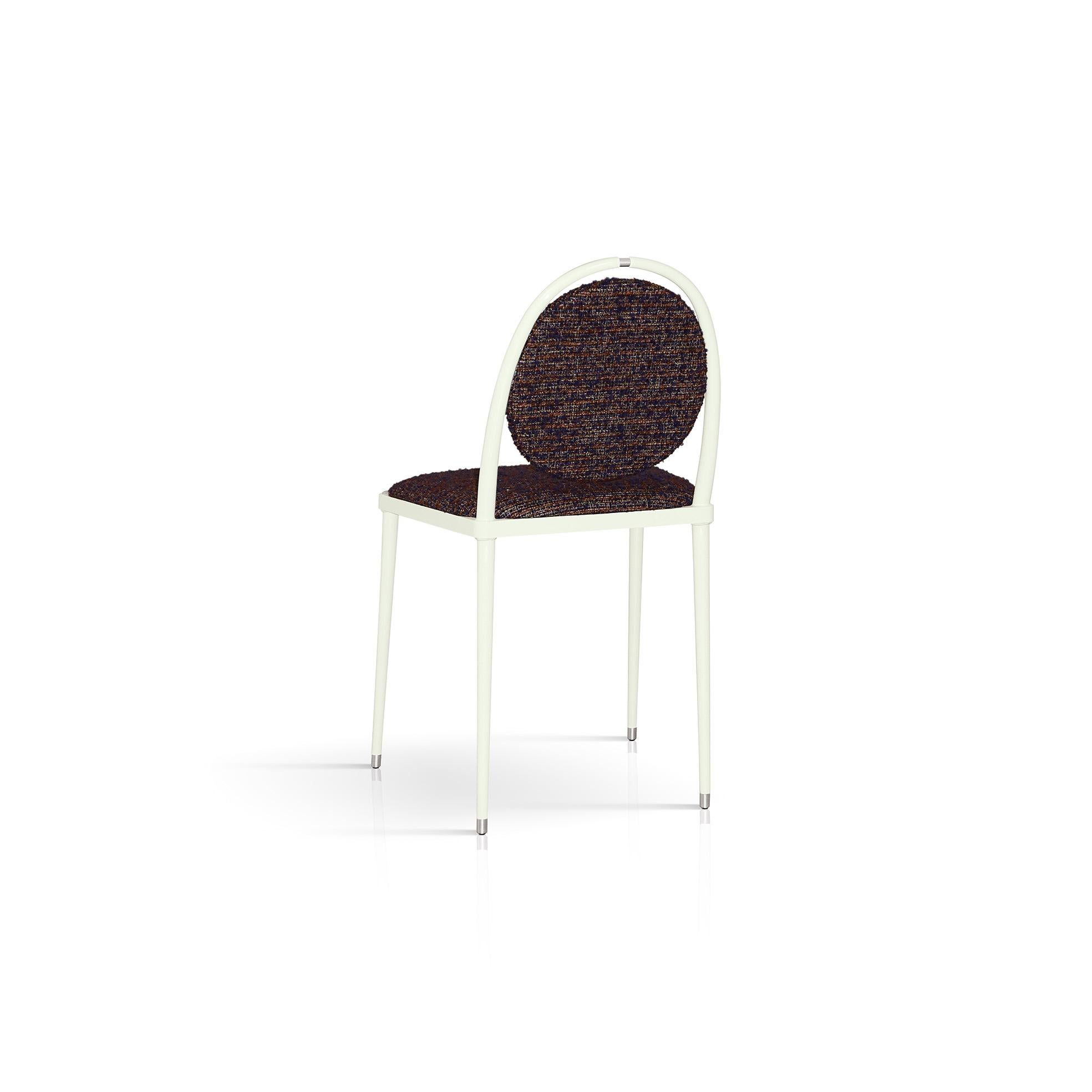 Part of the Balzaretti series of chairs distinguished for its rich colors of textiles and slender silhouettes, this chair will become the center of attention in any dining room with its enticing look. The geometric contours of the ivory gloss metal