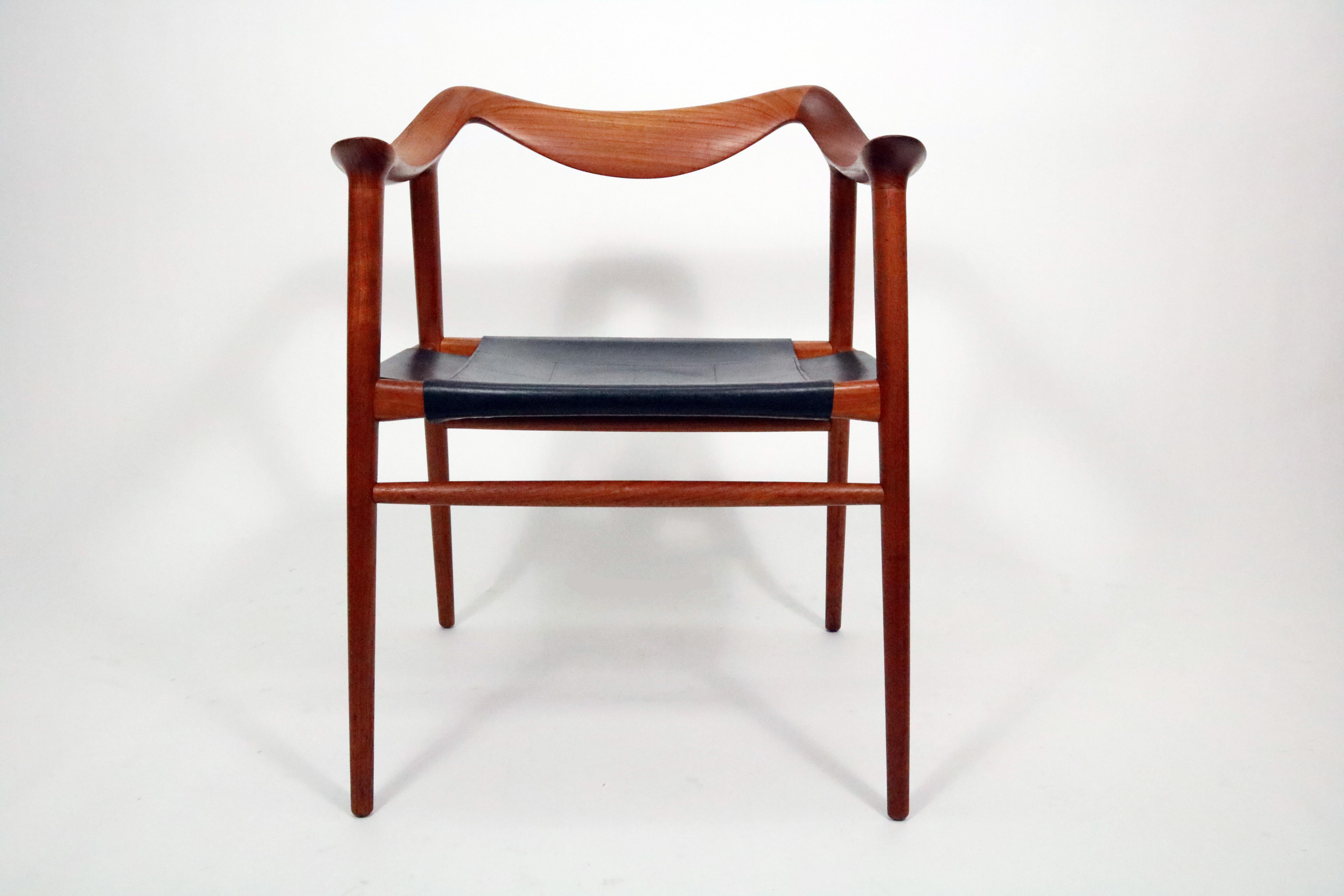 A stunning example of Adolf Relling's and Rolf Rastad's midcentury sculptural 'Bambi' chair for Gustav Bahus & Eft. Teak and original black leather. Norway, 1950s.