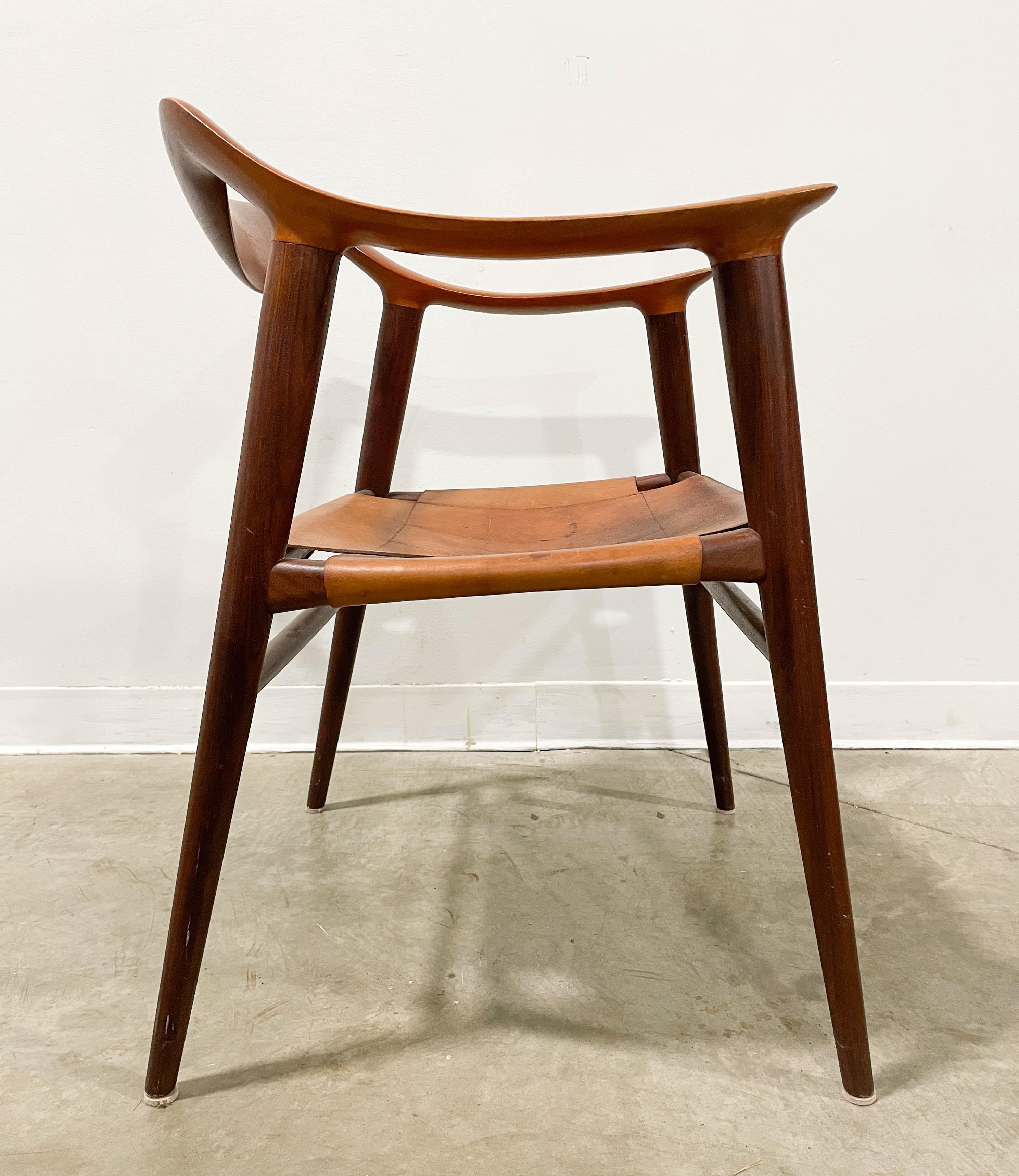 Crafted from teak and leather, this Bambi Chair designed by Rolf Rastad & Adolf Relling was manufactured by Gustav Bahus in Norway in the 1950s. The unique chair features superb joinery and a lightweight design. The original leather is in good
