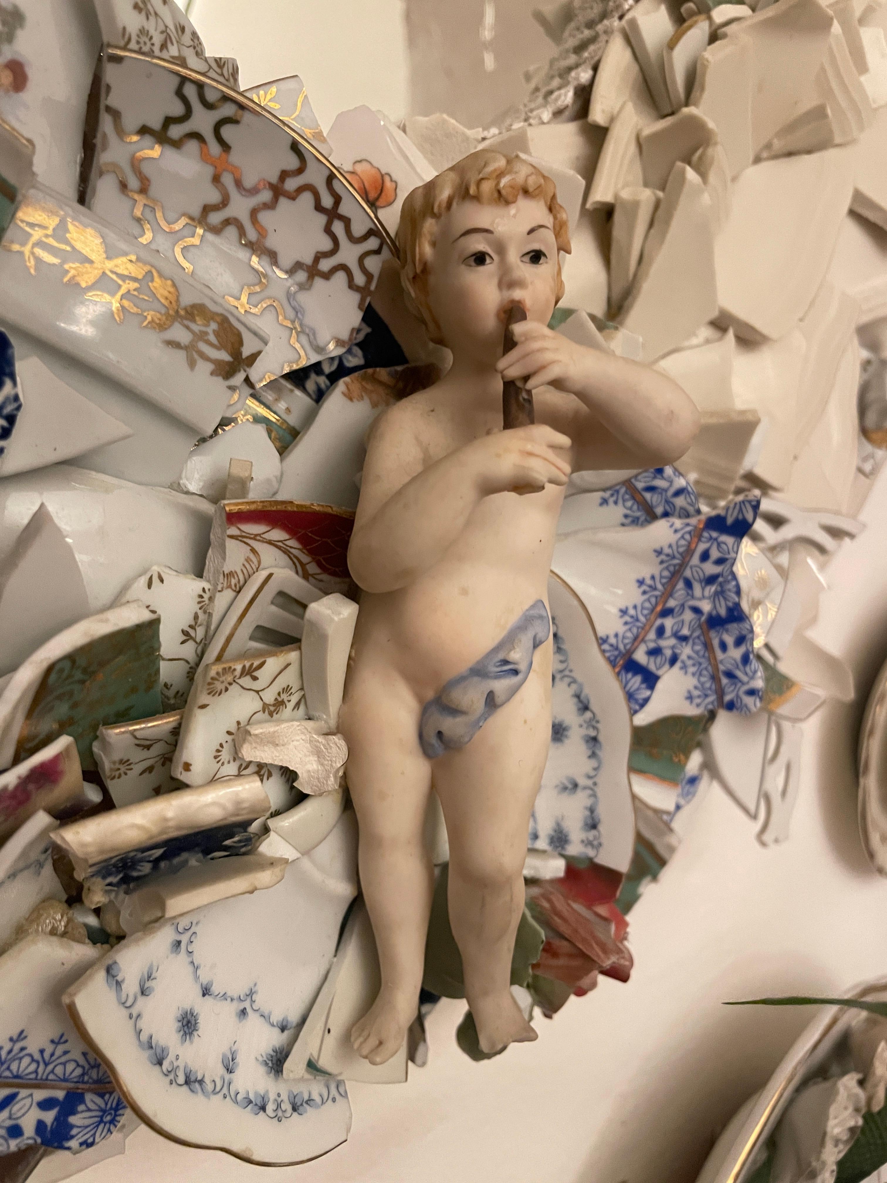 Specchio realizzato con frammenti di piatti in porcellana di differenti periodi e stili, bianchi, blu e oro.
Rose e bambinello che é parte di una vecchia statuina sono in Capodimonte, pavone in porcellana.
Come un kintsugi, ma non per riparare