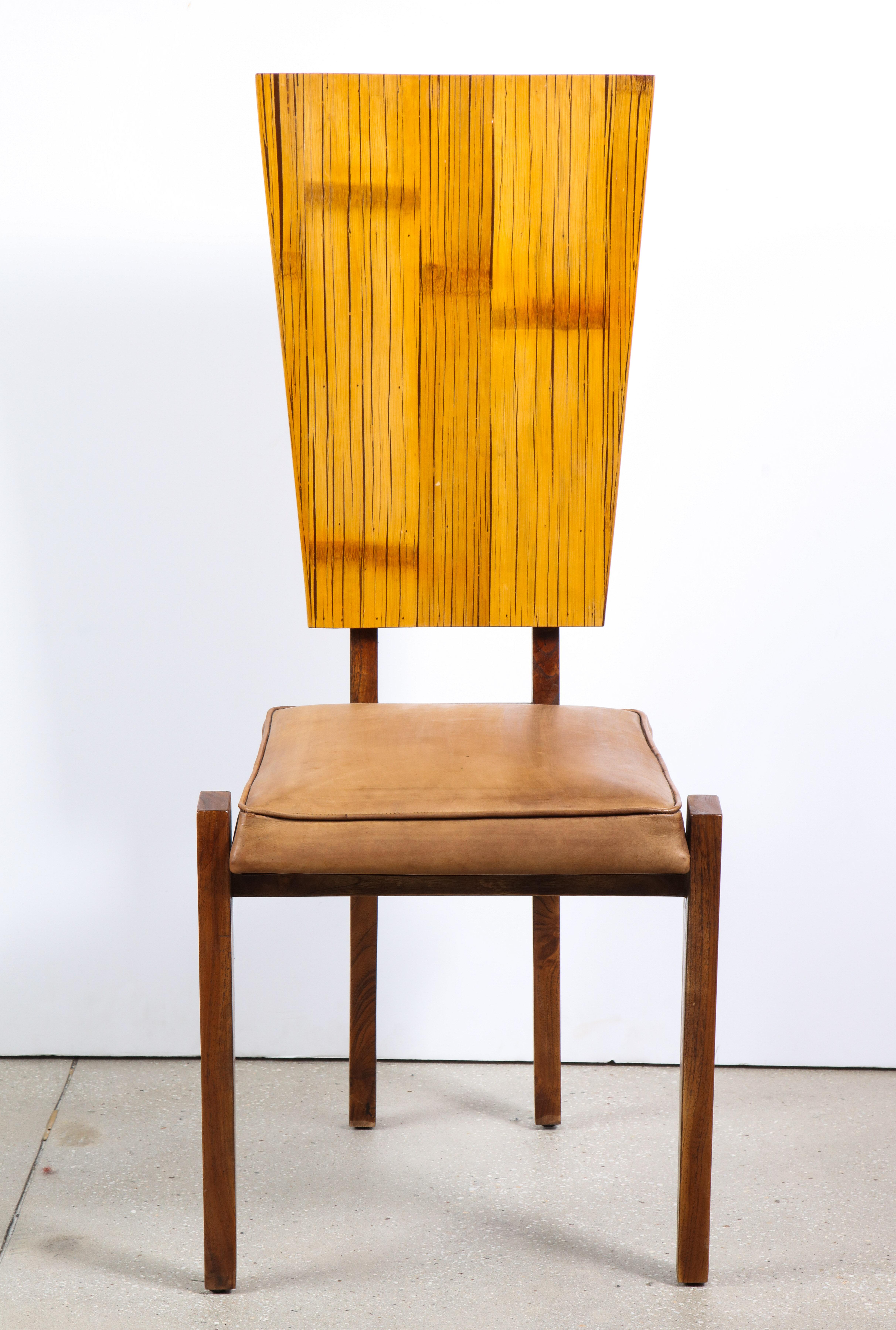 The ash frame supporting a bamboo veneered back and having a leather upholstered seat.
  