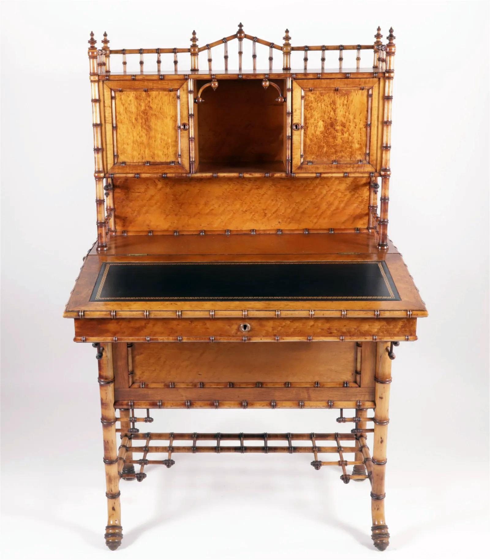 Bamboo and Birch Satinwood Desk
19th century

An exotic bamboo and satinwood desk in a Chinese Chippendale style. The upper section is topped with a pierced gallery accented with finials, sitting above a central open shelf flanked by two doors.
