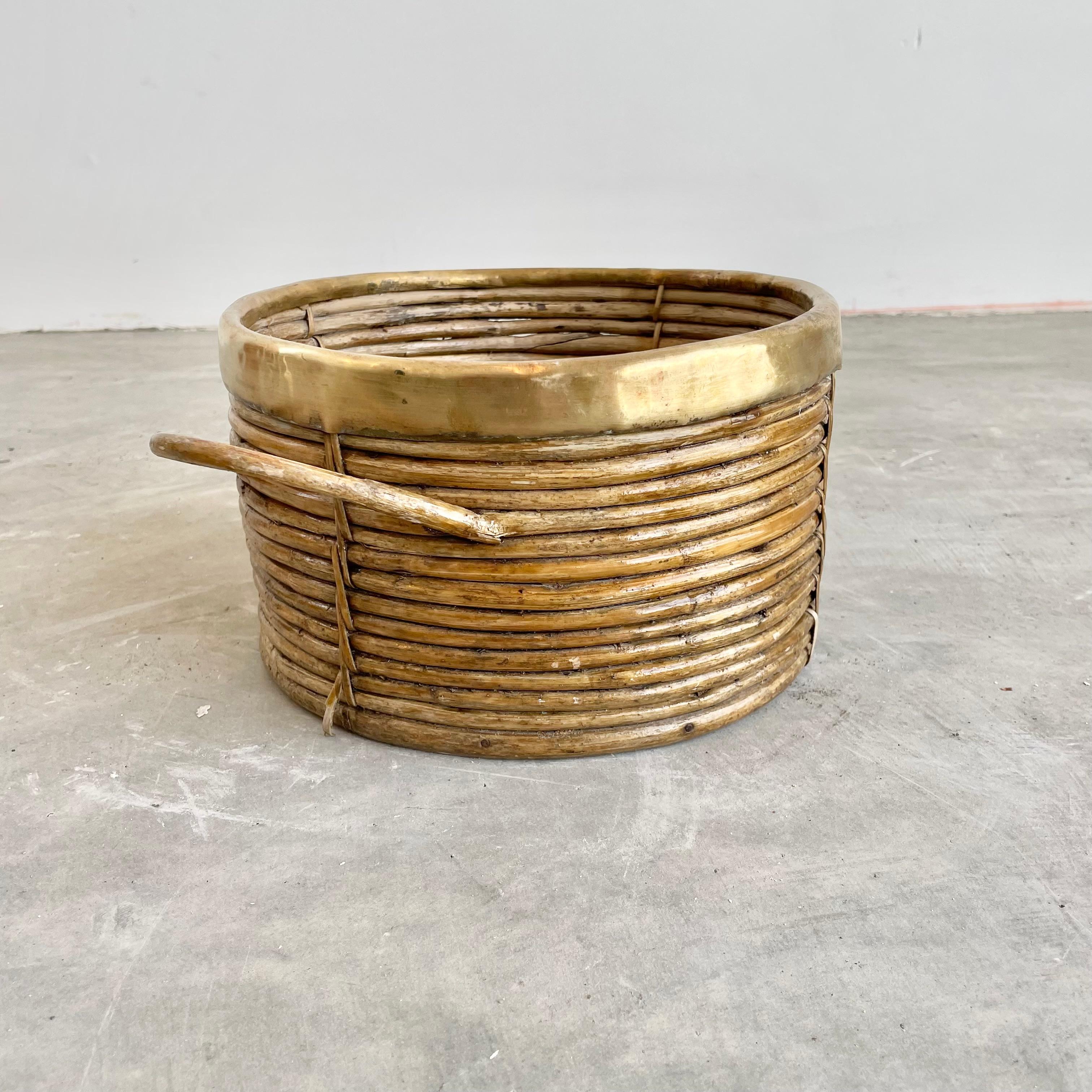 Fantastic bamboo bowl with brass trim and bamboo handles in the style of Gabriella Crespi. Great texture. Bamboo and rattan pieces are woven together with wicker ties as well as glued together. Bowl is sturdy and is able to hold heavy items as the