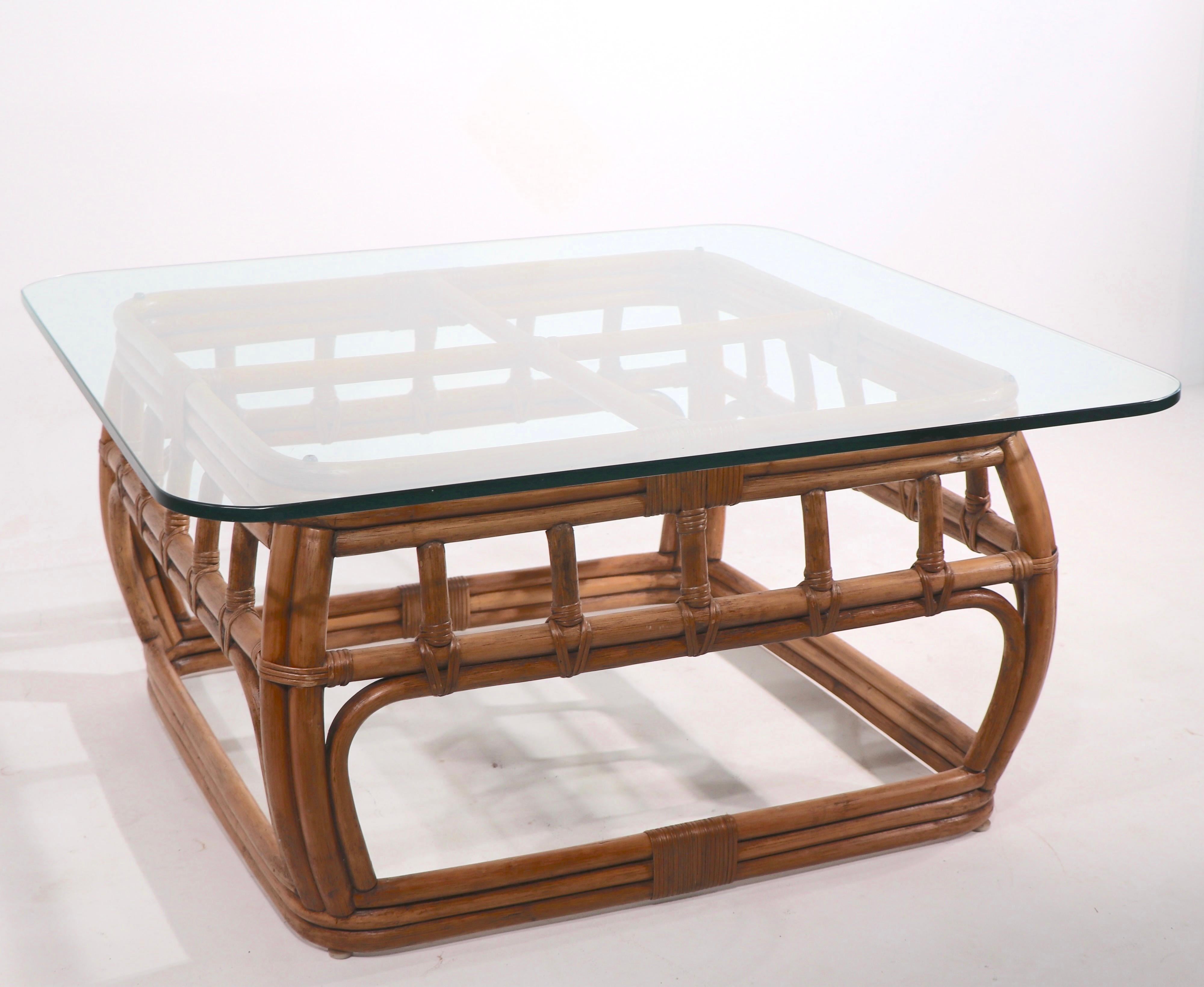 Chic and stylish bamboo coffee table with plate glass top. Reminiscent of McGuire, Henry Olko, Henry Link etc, unsigned. Original, clean, ready to use condition. Please view the companion pieces, sofa, lounge chair and tables we have listed