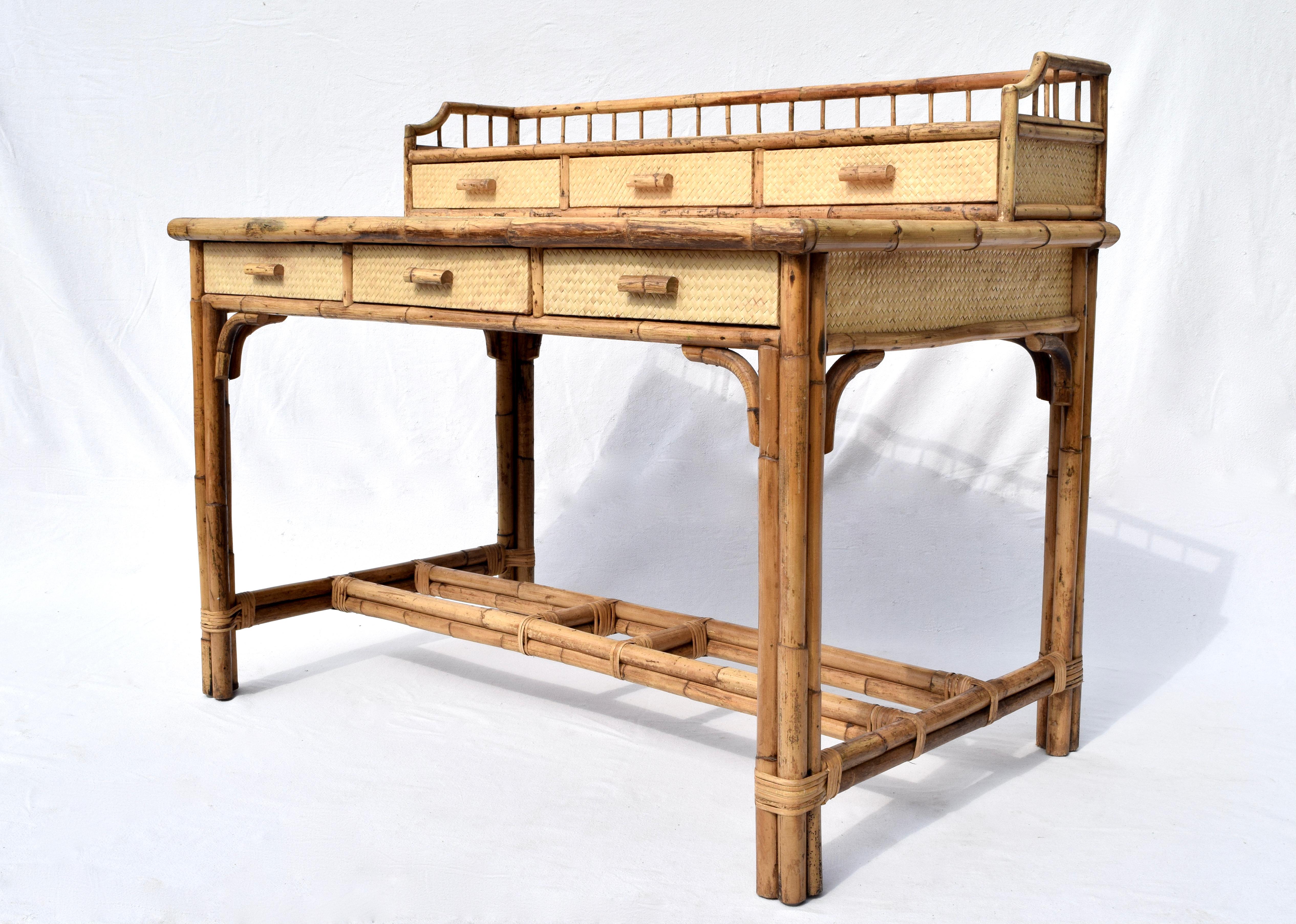Midcentury British colonial 6-drawer writing desk with tiered gallery and two custom glass tops. Wrapped in grass cloth and framed in bamboo, this exceptionally preserved vintage desk features generous work surface & storage. Finished on all sides