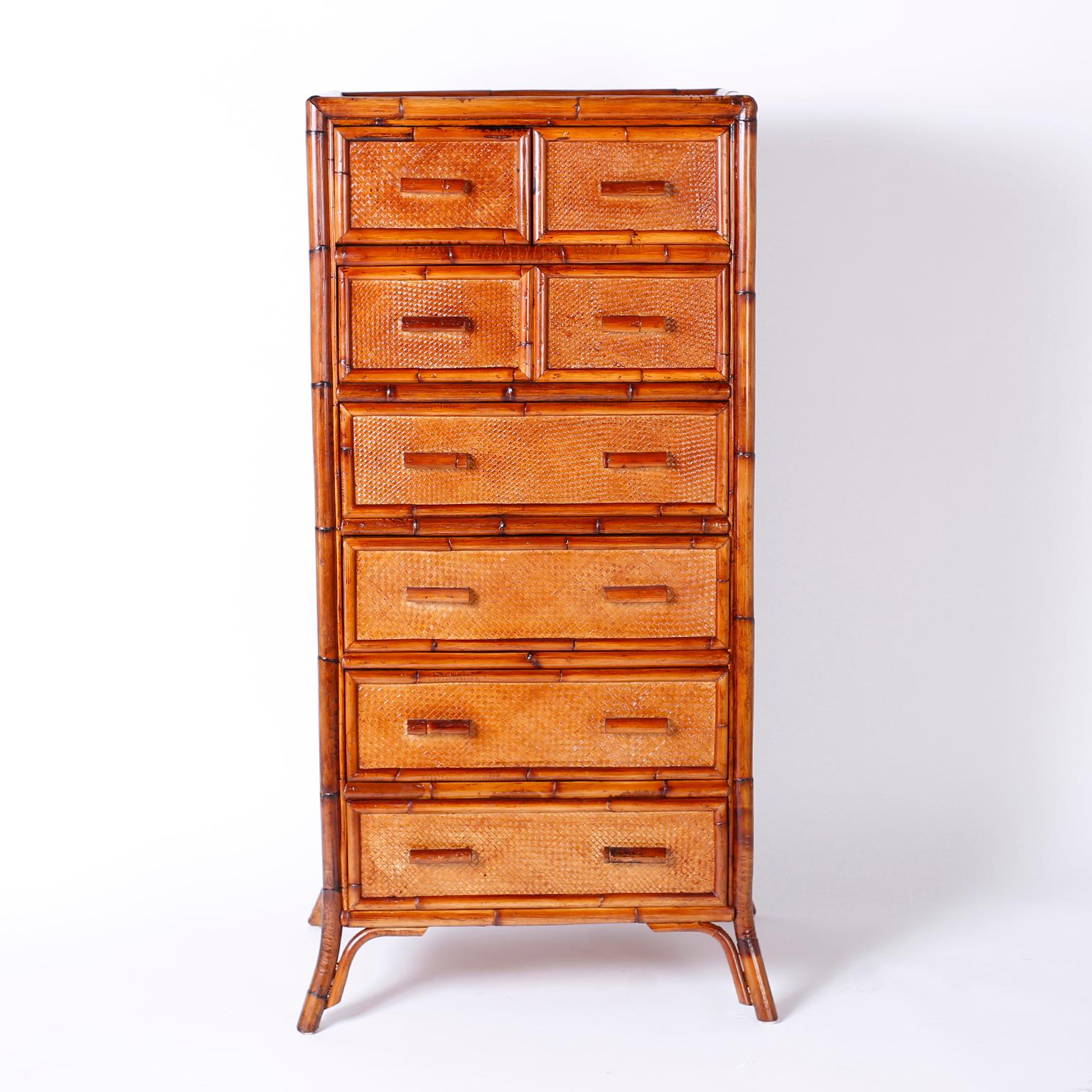 Gentlemen's chest of eight drawers with a casual elegance and featuring a bamboo frame, grasscloth panels, stylized sunrise designs on the sides and splayed legs.