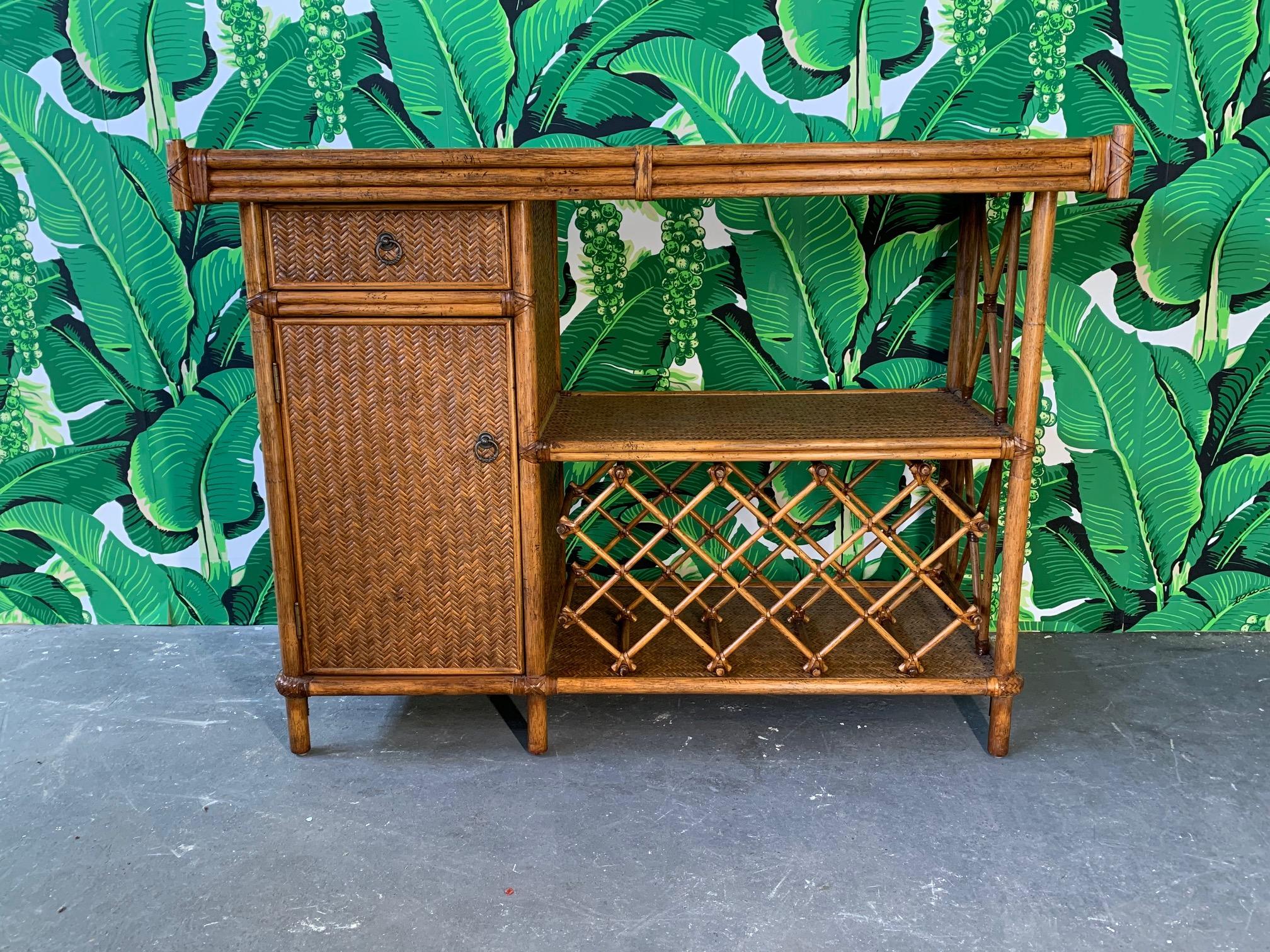 Vintage dry bar in bamboo in rattan features removable wine rack and stacked bamboo detailing. Very good condition overall.
