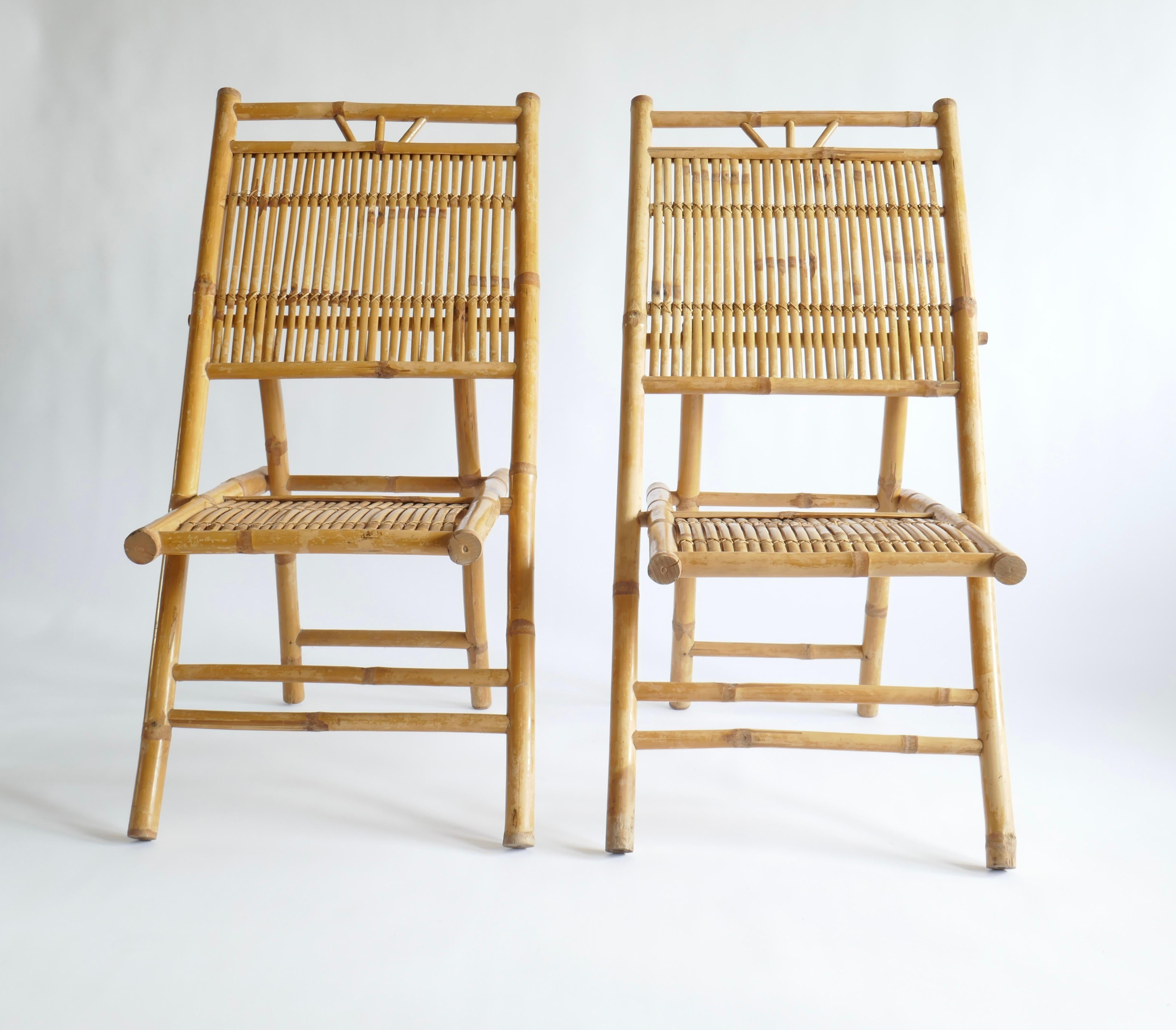 Elegant pair of Italian Mid-Century Modern Rattan and bamboo side chairs or lounge chairs. They have a classic X-form leg structure and are constructed using rattan slatting arranged and hand sewn together to allow transparency between the slats,