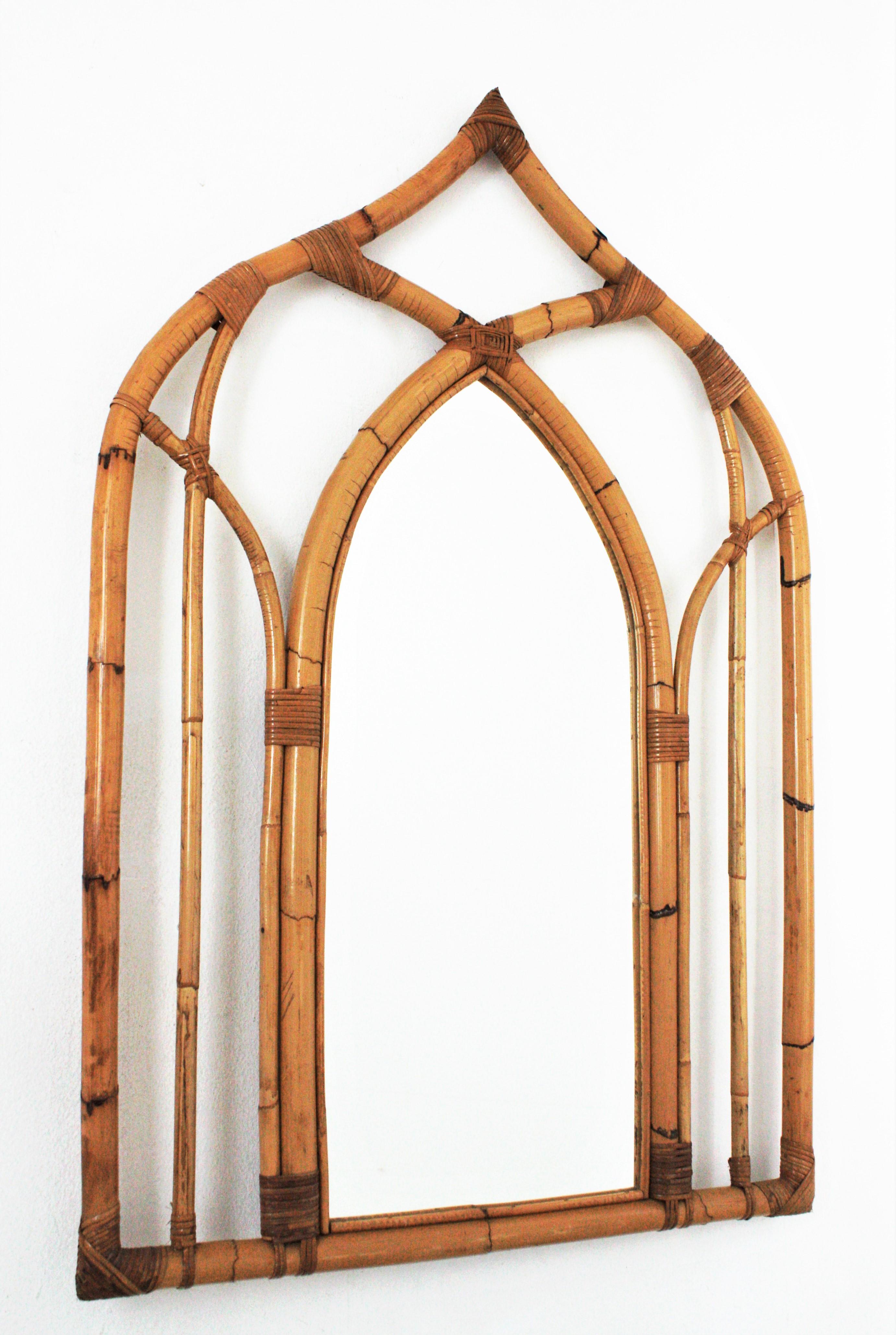 Eye-catching Arabic style bamboo large mirror, Italy, 1970s.
This bamboo mirror has Arabic and Gothic style accents and all the taste from Italian designs from the mid-20th century period.
The frame was handcrafted with bamboo canes joined between