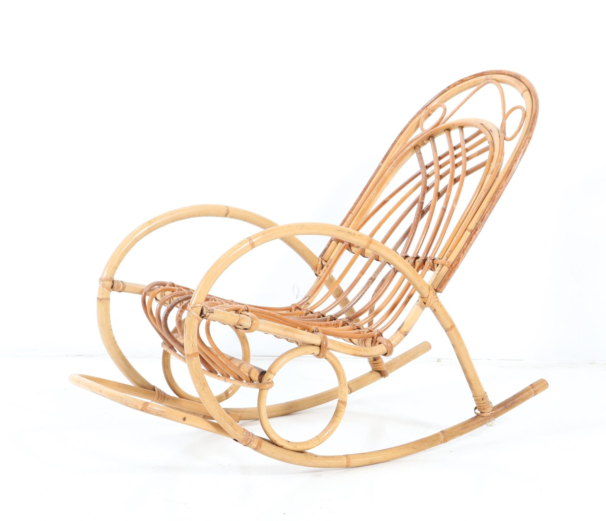Stunning and rare Mid-Century Modern children's rocking chair.
Striking French design from the 1970s.
Executed in bamboo and rattan.
This wonderful Mid-Century Modern children's rocking chair is in very good original condition with minor wear