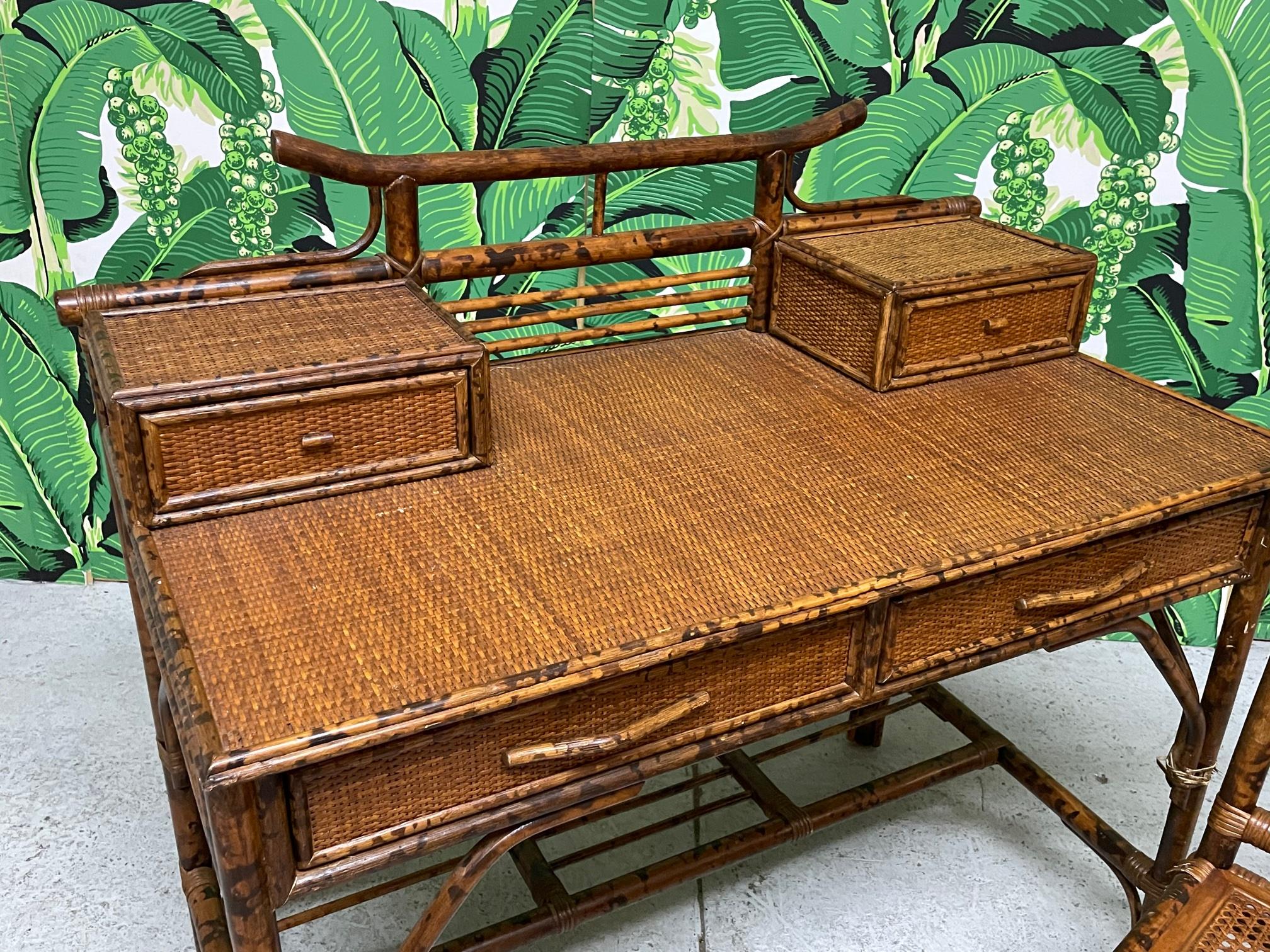 Bamboo and rattan writing desk features Asian chinoiserie style along with a matching chair. Made for Bloomingdale's. Very good condition with minor imperfections consistent with age. Desk measures 41.5