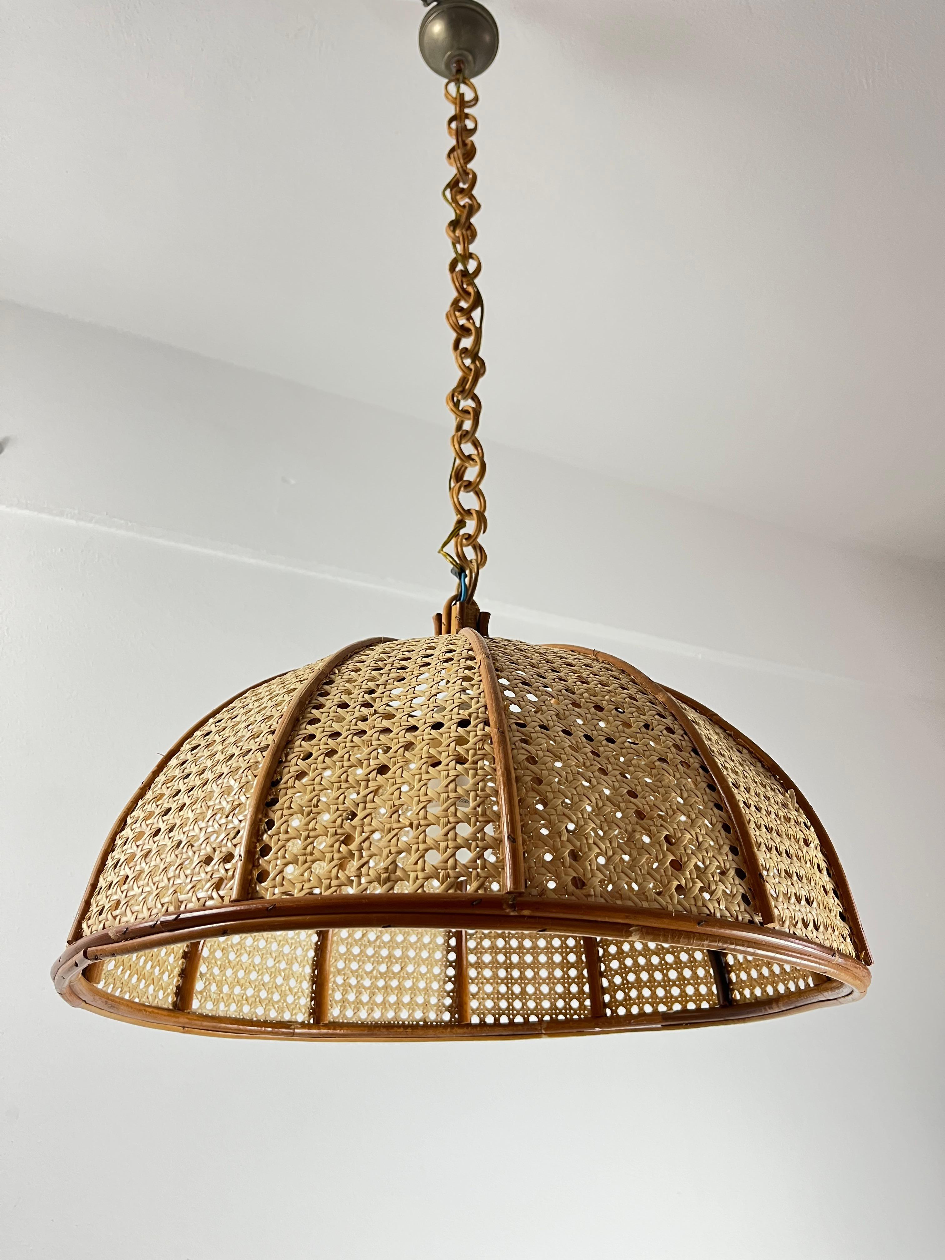 Bamboo and rattan pendant lamp, Italy, 1970s
Intact and working, E14 lamp socket.Good conditions. 
Found in a villa near the sea.