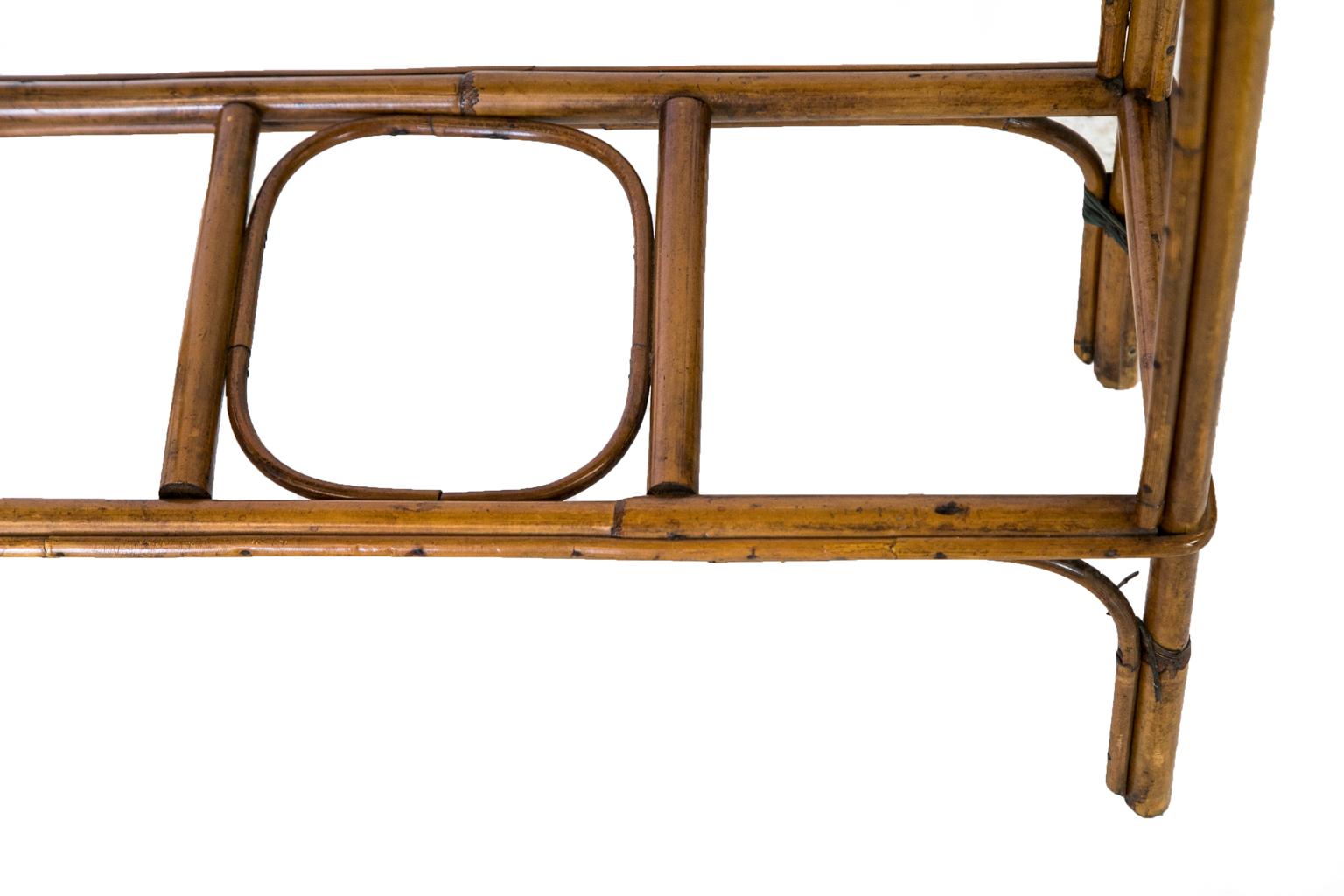 The frame of this planter is made of bamboo with an interlaced wicker body and interlaced with painted teal diamond lozenges on the edges and top.
 