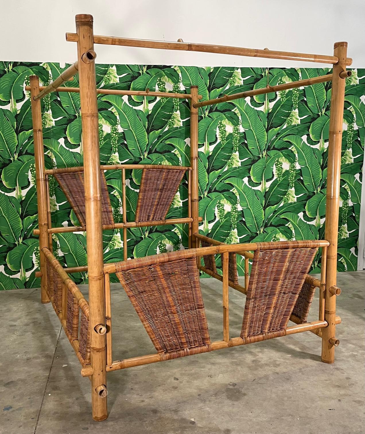 Queen size canopy/poster bed constructed from oversized bamboo.. Rattan detailing woven throughout. Good vintage condition with imperfections consistent with age and use. May exhibit scuffs, marks, or wear, see photos for details. One top rail has a