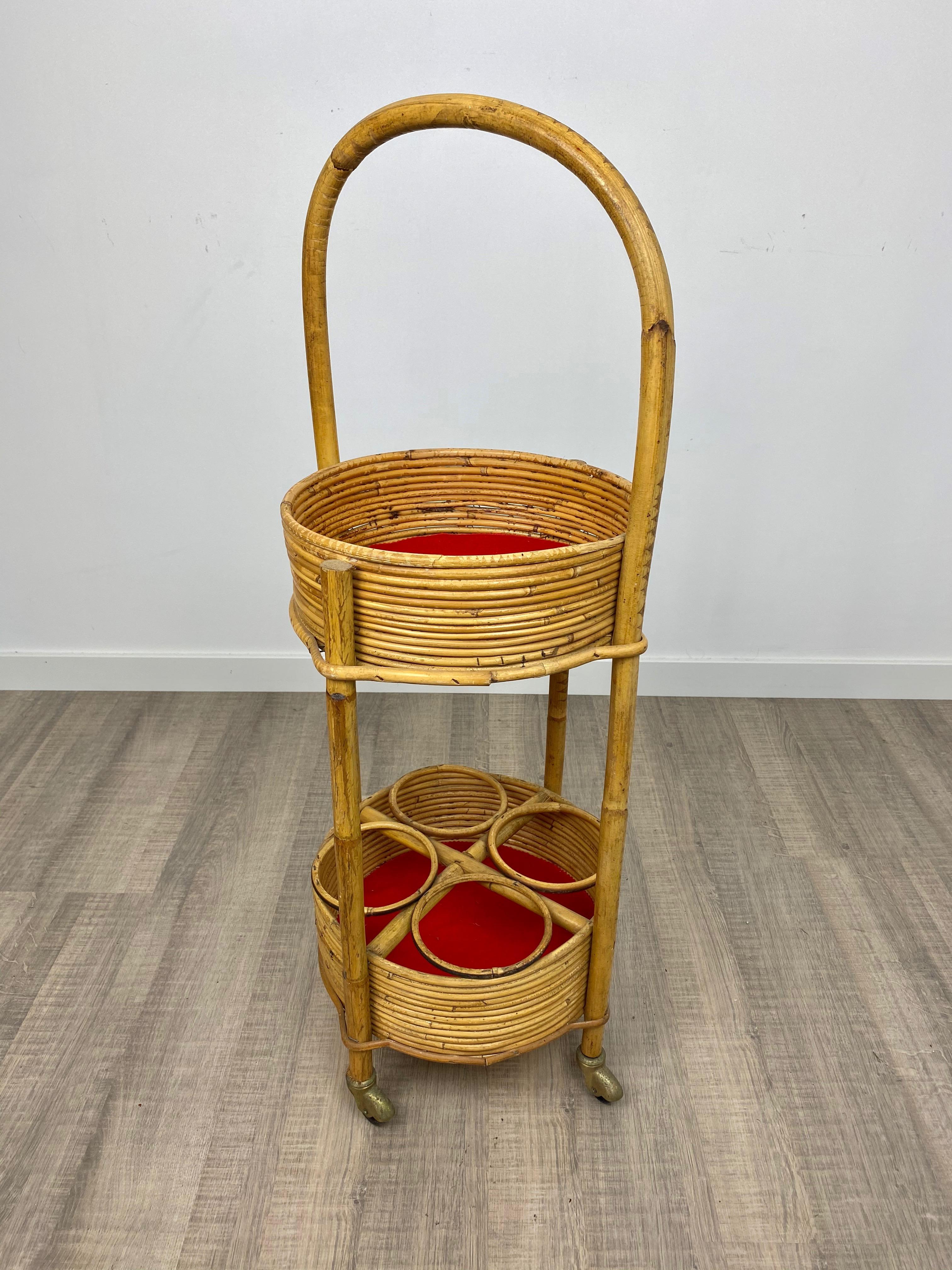 Trolley bar cart and bottle holder in bamboo and rattan with red velvet padding and handle. Made in Italy, circa 1960.