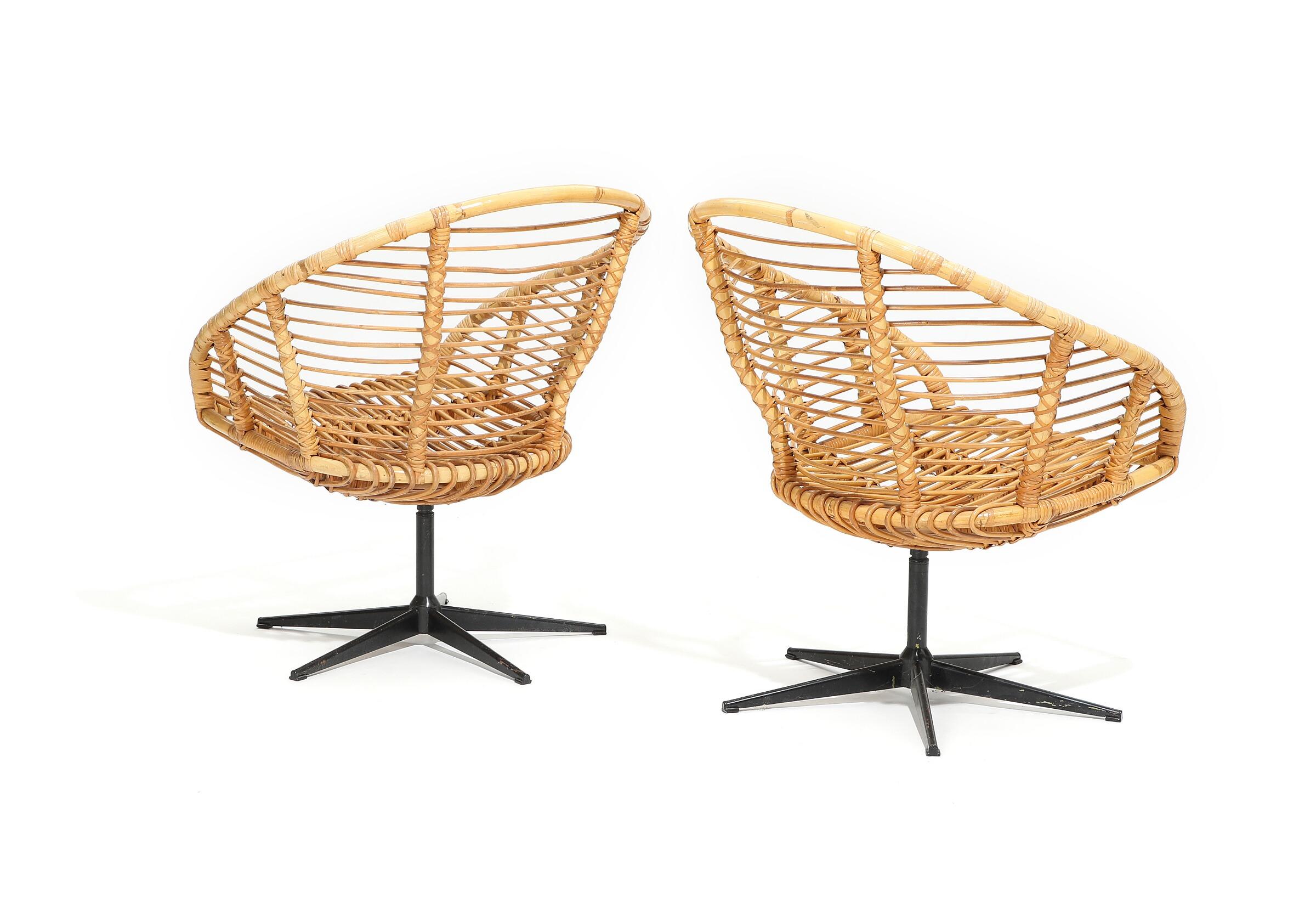 A pair of Danish rattan and bamboo swivel chairs and coffee table with glass top and black lacquered metal frame. Measures: Chairs 30