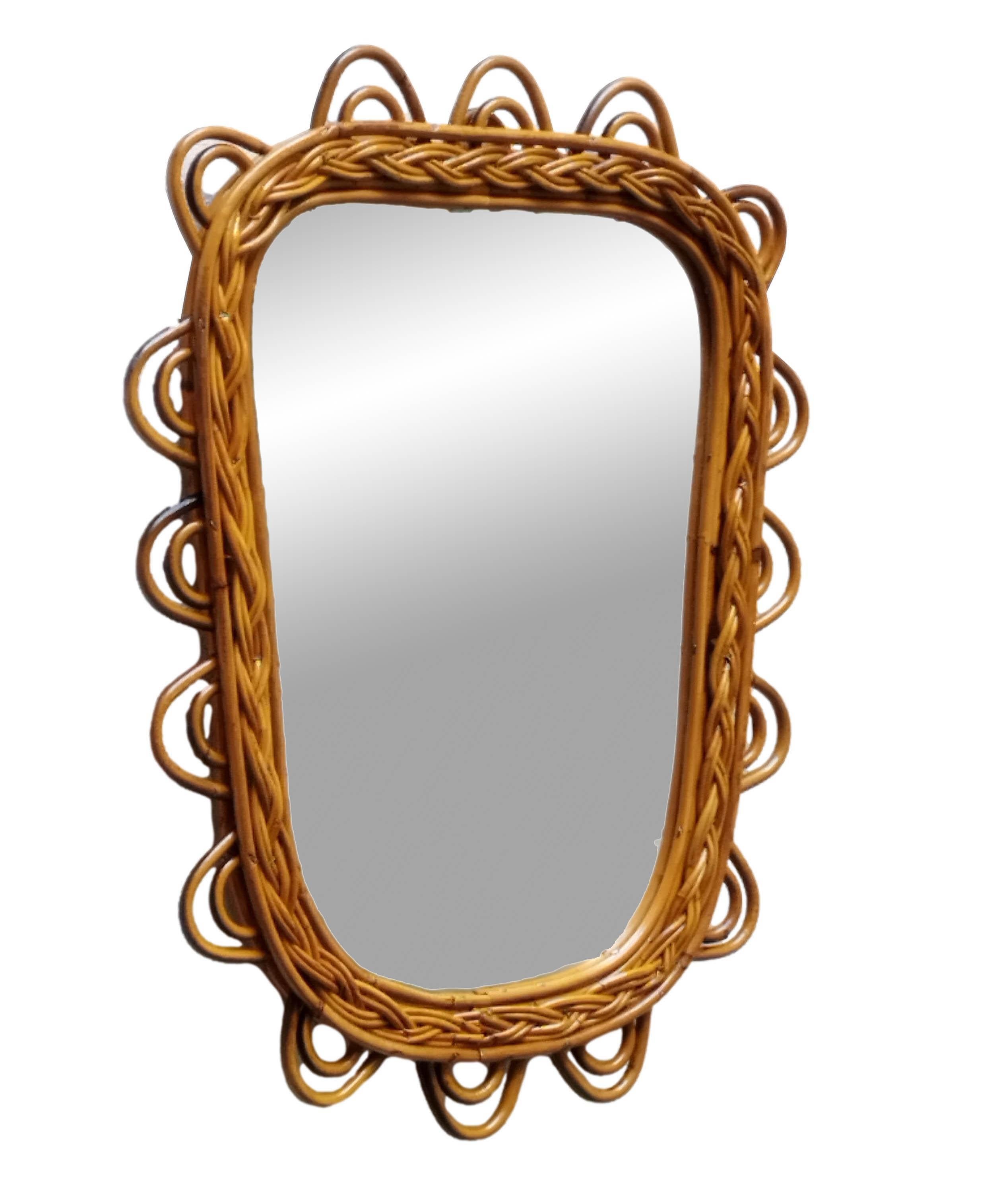 This very decorative mirror was handmade in Italy in the 1960s and is in perfect condition. It has a beautiful shape and features a magnificent honey-coloured patina.
 