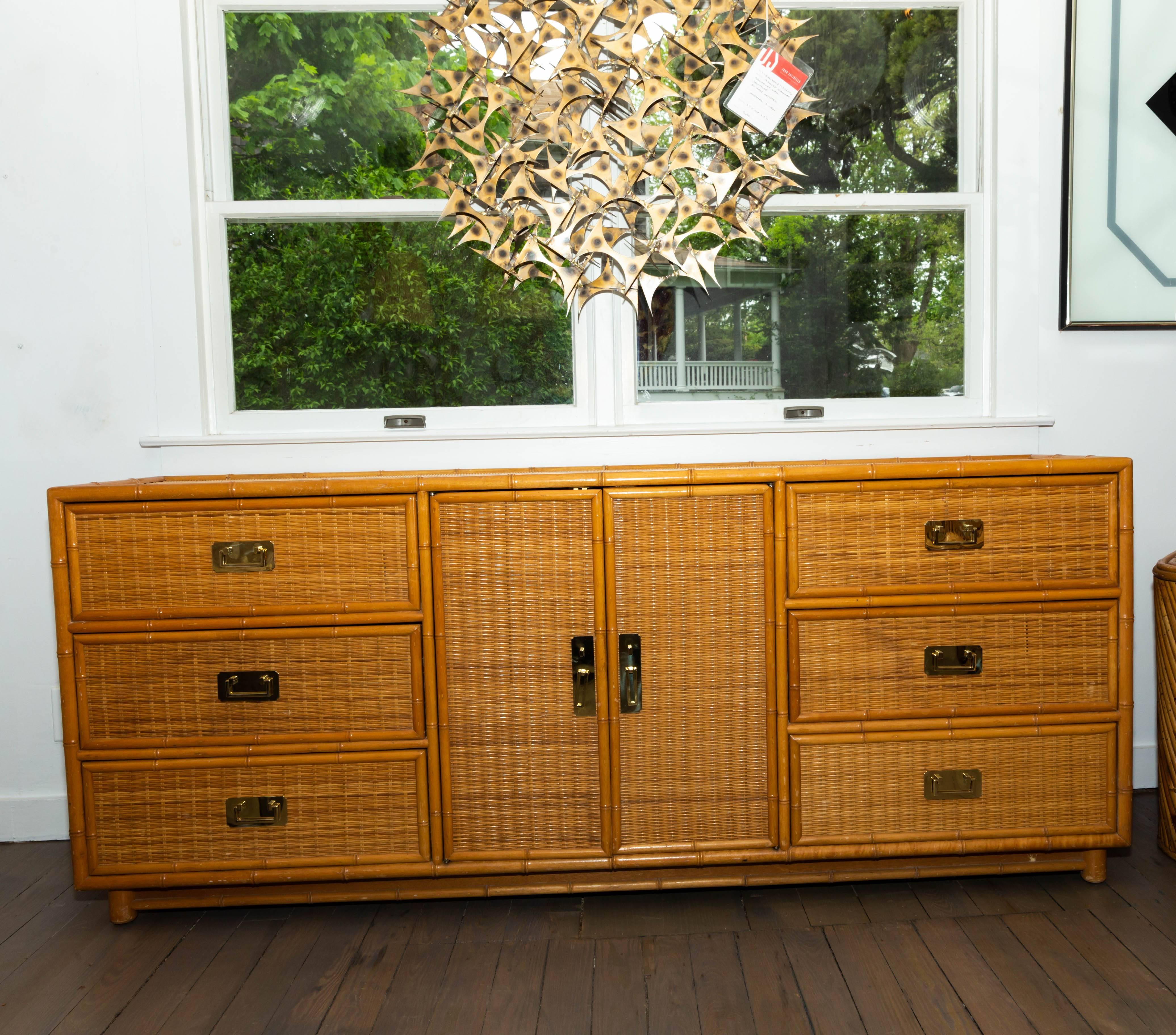 Bamboo and reed cabinet with brass hardware.
