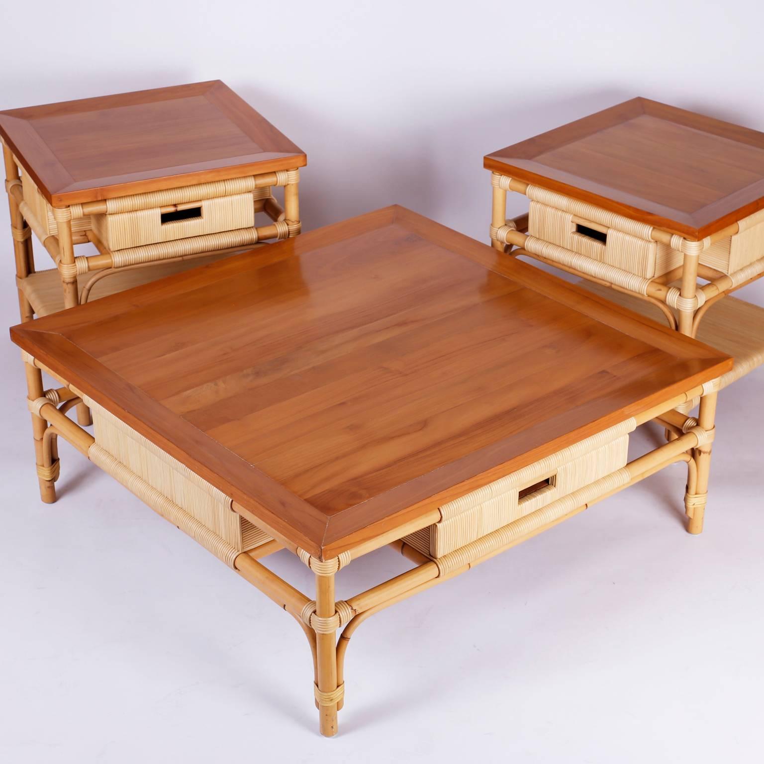 Dapper large square coffee or cocktail table with a cross banded poplar top over a bamboo frame wrapped with reed, finished all around with a drawer on two sides. Highest quality with a dynamic casual, elegant form. Branded Donghia at the bottom.