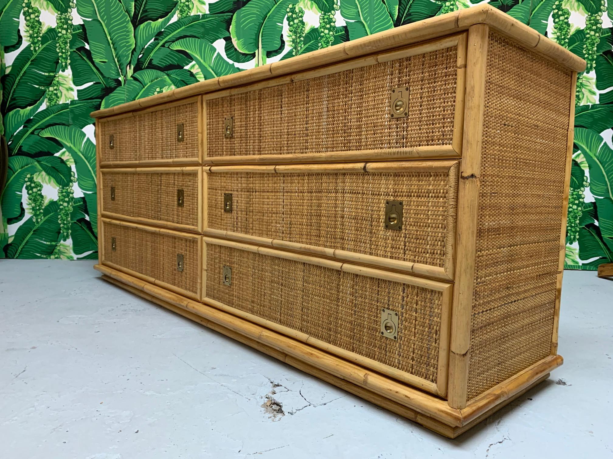 Double dresser features bamboo detailing and woven rattan wrapped surfaces. Brass hardware adds a Hollywood Regency touch. Very good condition with very minor imperfections consistent with age.