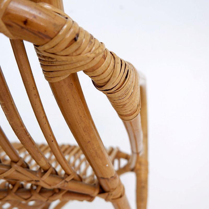 Armchair made out of bamboo with flowy curvy shapes.