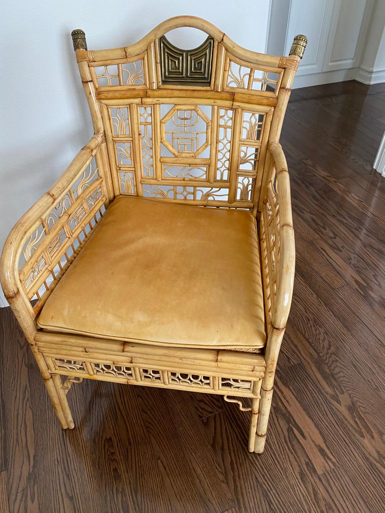 This bamboo armchair is rimmed in brass accents well designed indoor or out!