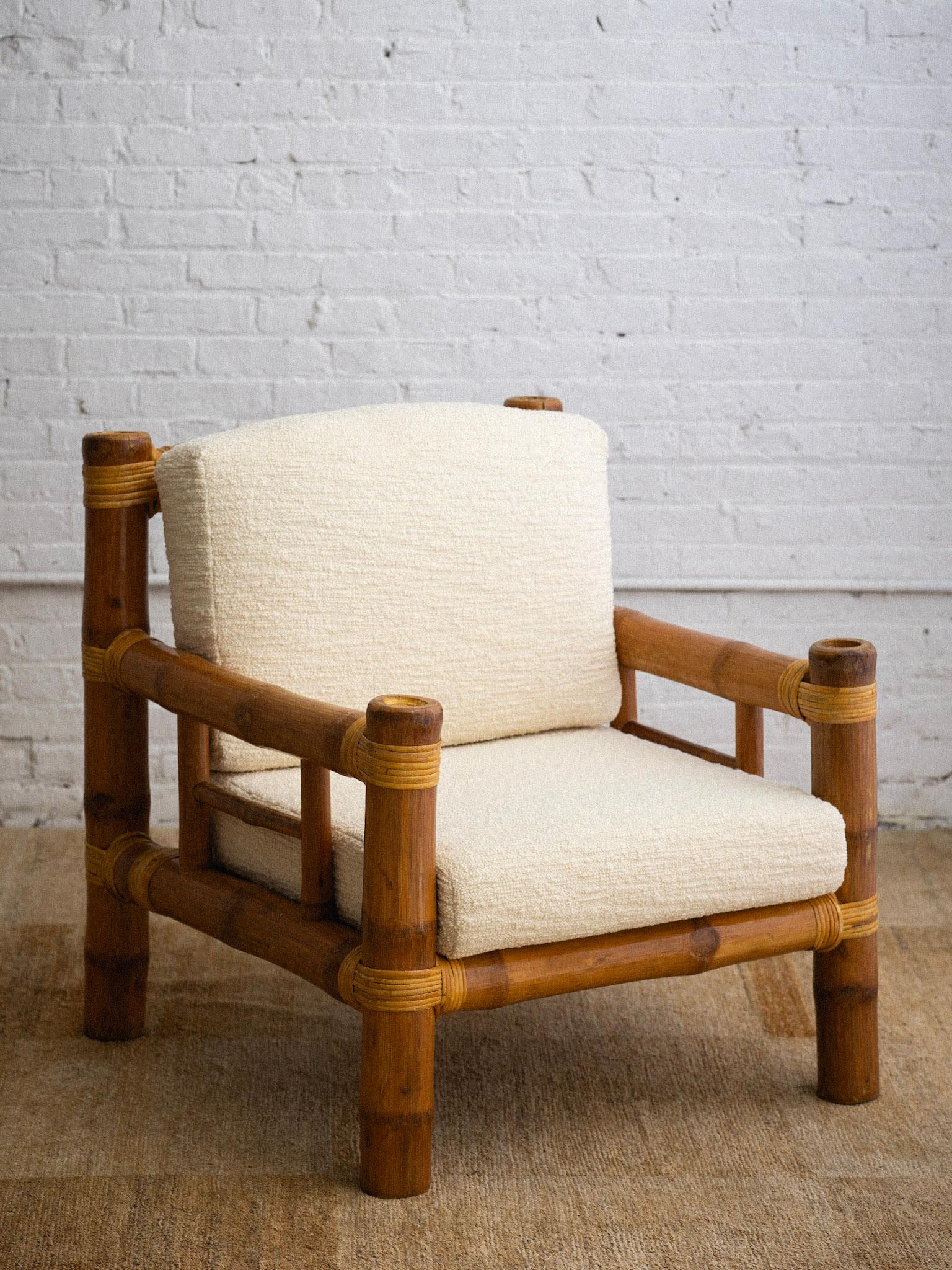 A 1980s bamboo armchair in the style of Antonio Budji Layug. Large bamboo frame with slat back and base. Cane wrapping. Newly made cushions in a high quality cream wool bouclé.