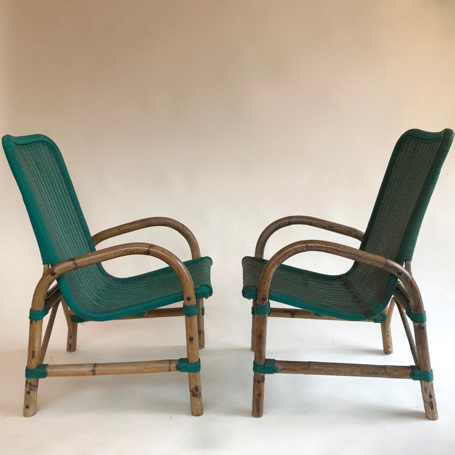 Comfortable high back bamboo rattan armchairs with an amazing green thin plastic webbing seats, 1950s-1960s, a pair by Rotan, Torino. Untouched but could easily be polished if needed.