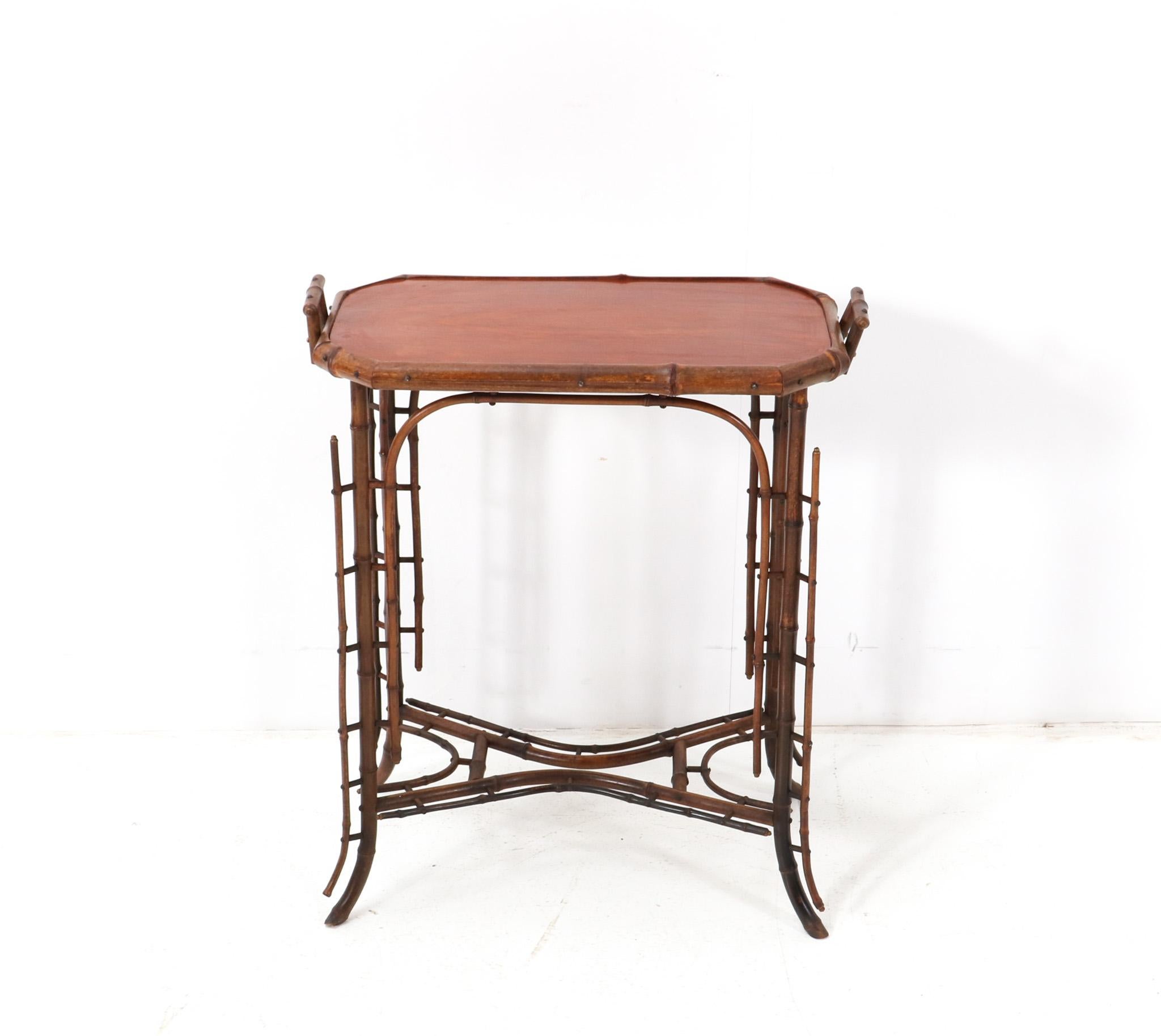 Stunning and rare Art Nouveau tea table.
Striking Dutch design from the 1900s.
Original bamboo frame with solid padouk top.
This wonderful Art Nouveau tea table is in very good condition with minor wear consistent with age and use, preserving a