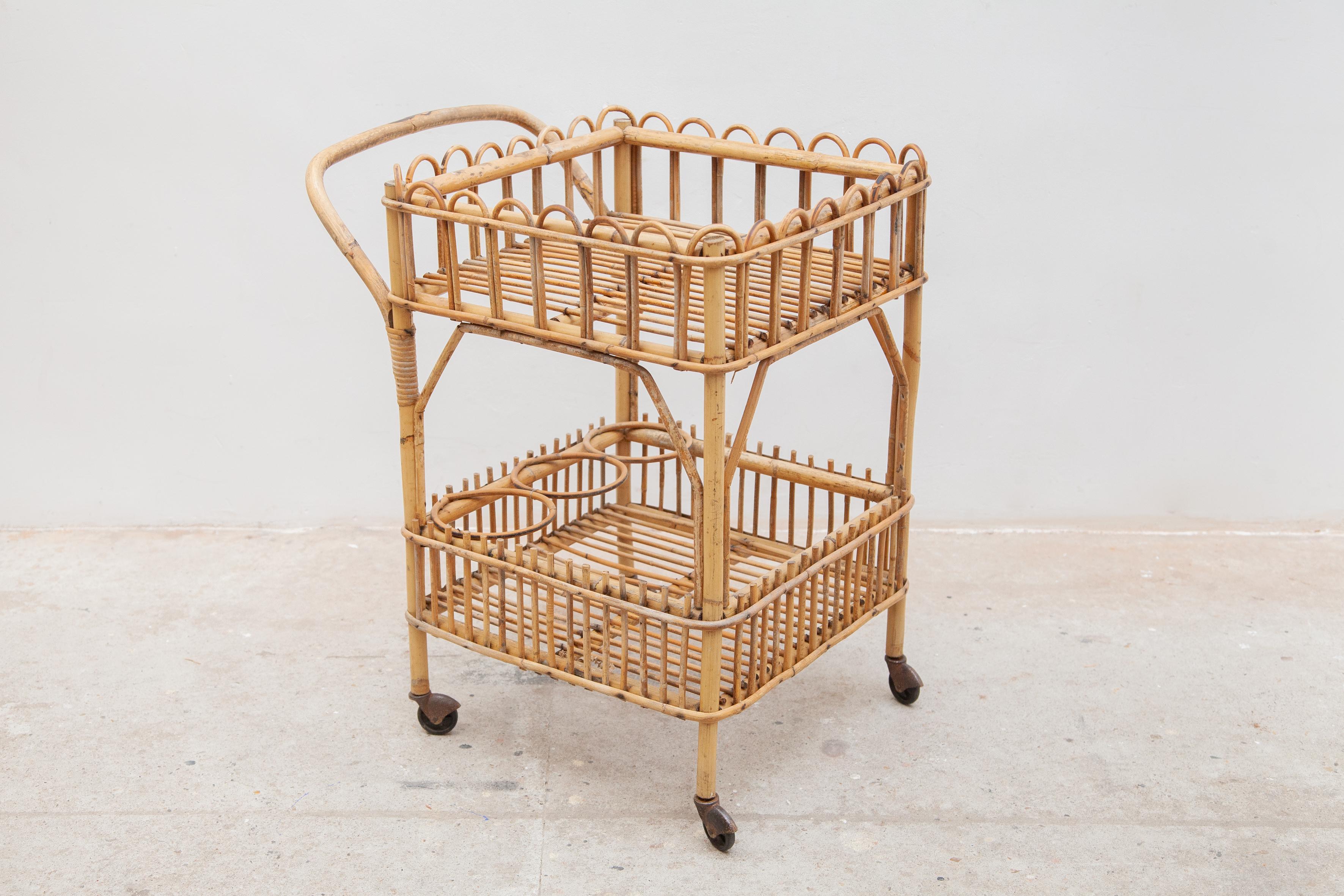 A very nice and decorative bamboo bar cart, serving trolley designed in the 50s Italy, storage for 3 bottles. In original good condition.