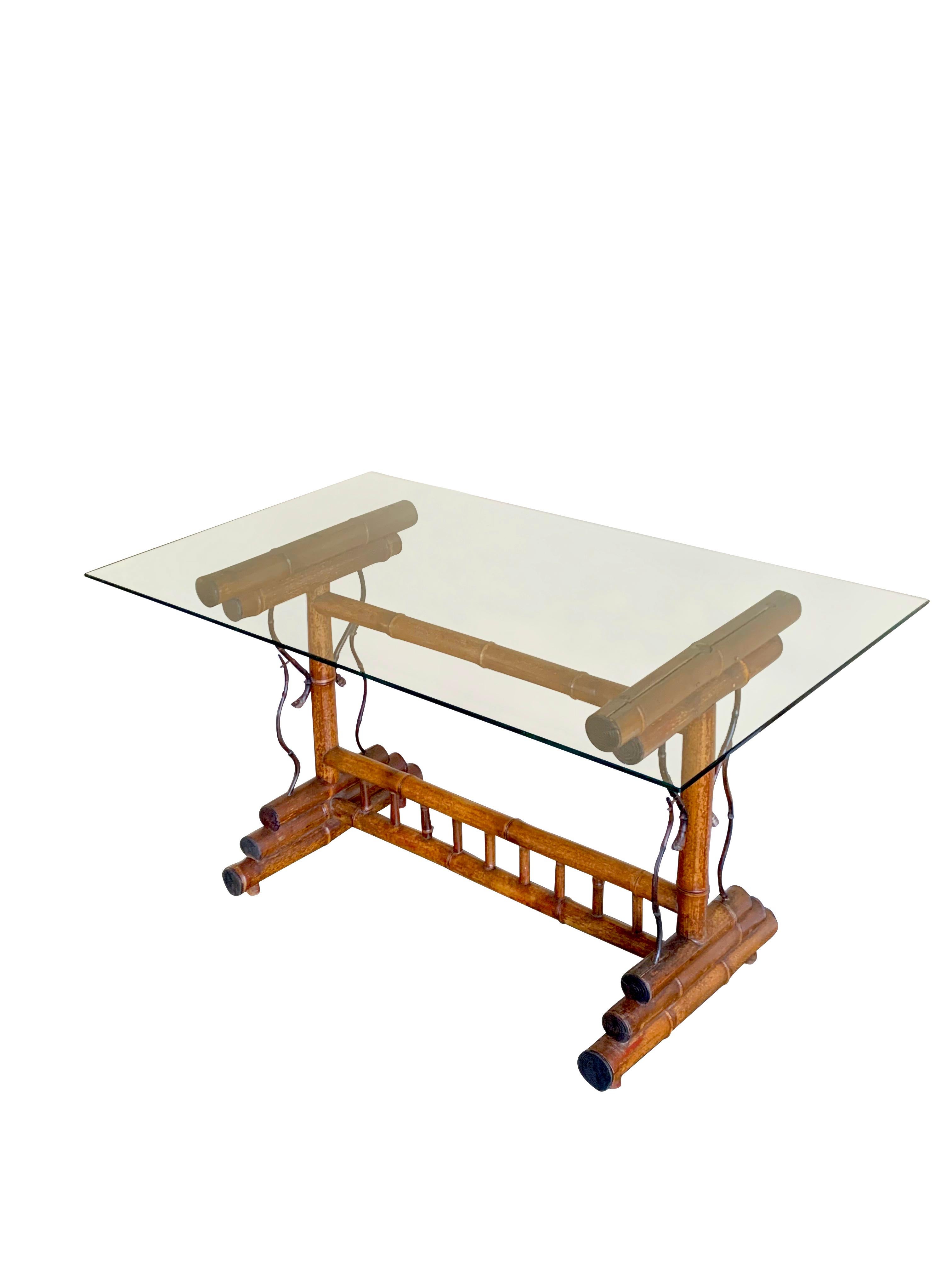 1940s French bamboo base writing desk with glass top.
The desk has been recently refurbished and has a beautiful natural aged patina.
Base measures 35 x 20.
Glass top measures 48 x 28.
Overall height 26.5.
Glass top has minor scratches due to