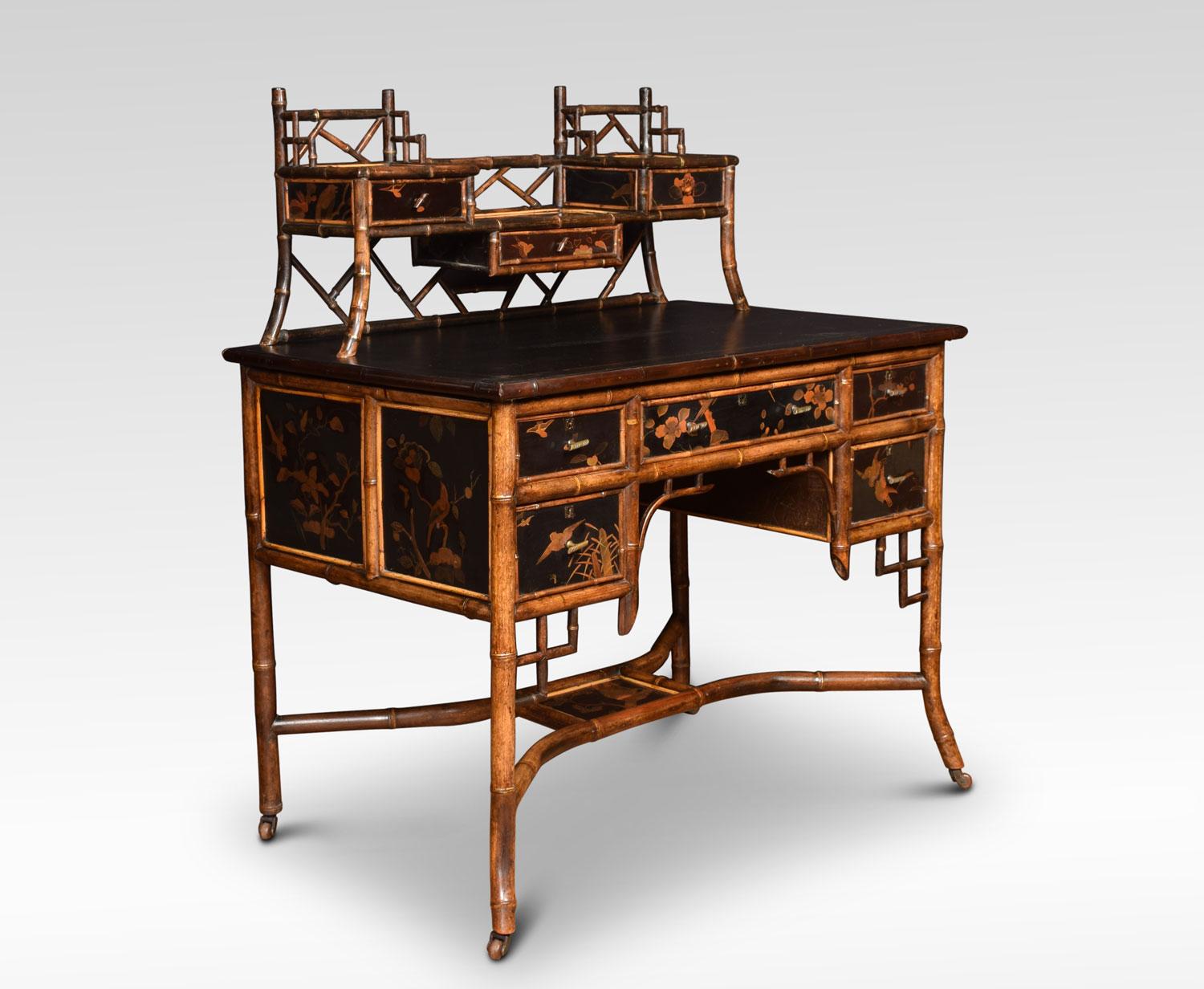 19th century bamboo black lacquered writing desk having stage gallery with an arrangement of three short draws. To the large black leather inset writing surface above large central draw flaked by two shorter draws to each side. Having painted birds