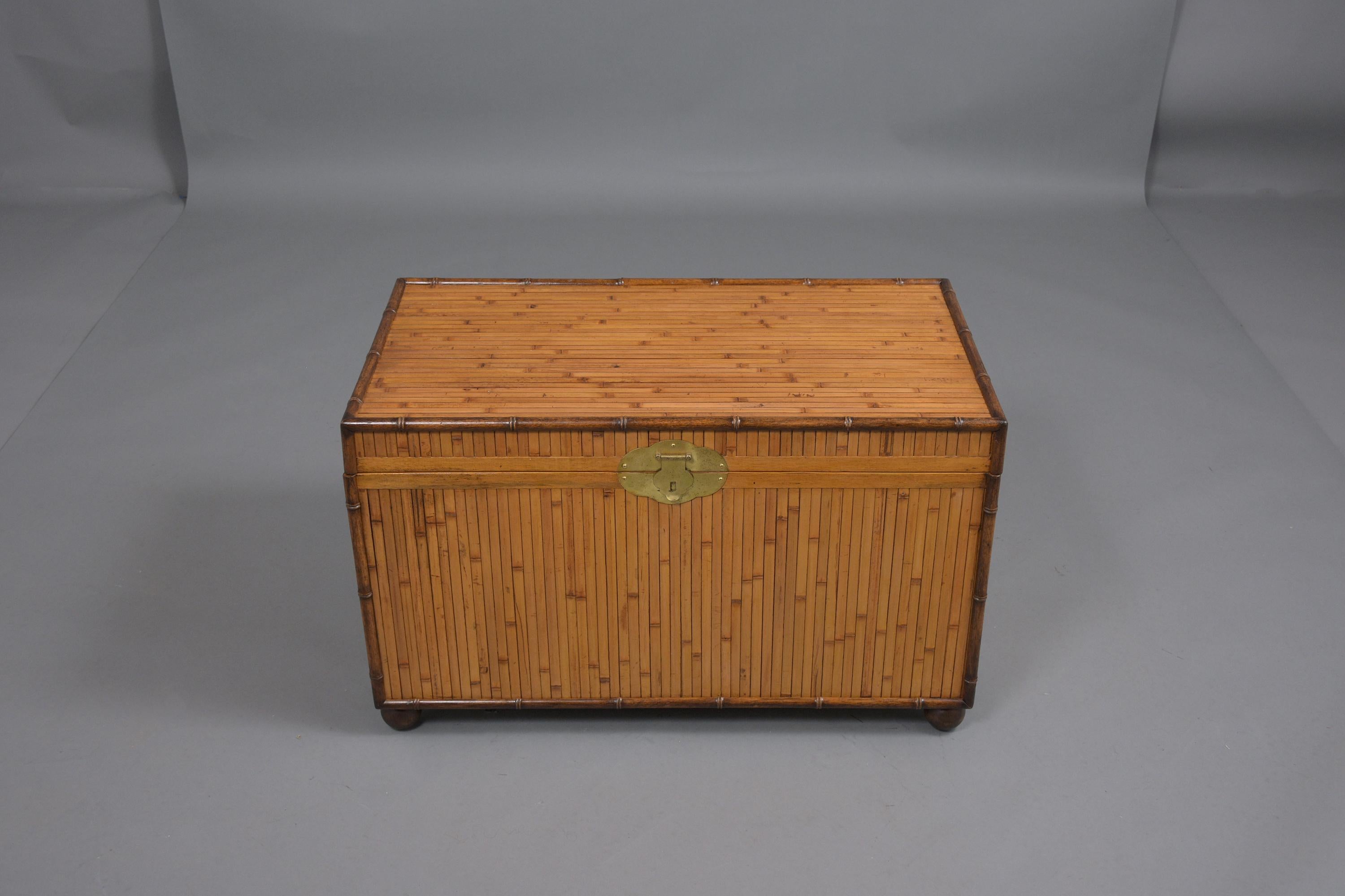 An extraordinary 1980s trunk crafted out of bamboo and wood is in a good condition and covered in bamboo featuring its original golden color and walnut finish. The trunk is newly shellacking, waxed, and polished developing a beautiful patina