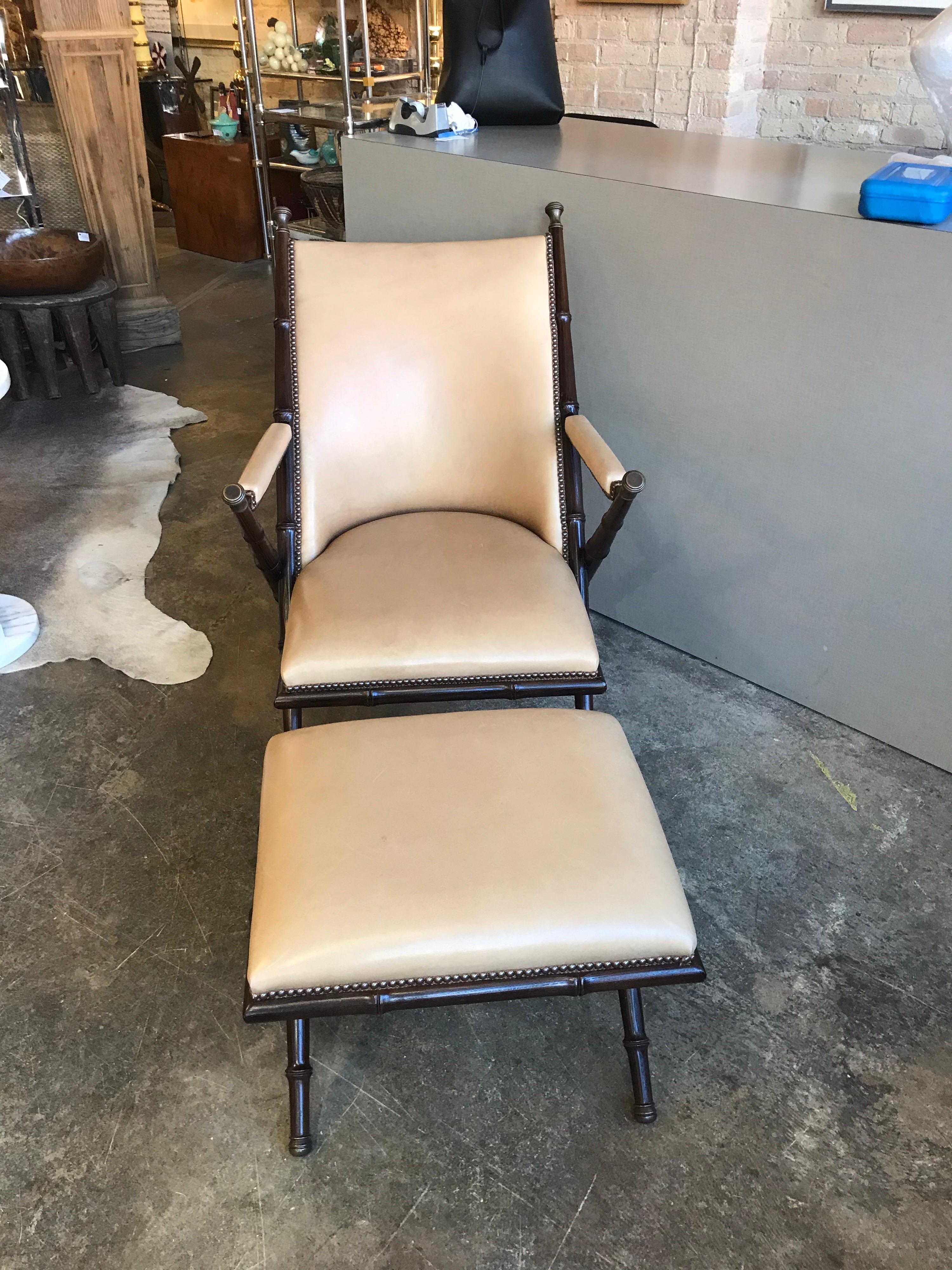 This is a vintage wooden lounge chair with brass caps and decorative elements and leather upholstery. It has a matching leather ottoman and is made by the Hickory Chair Co. North Carolina.