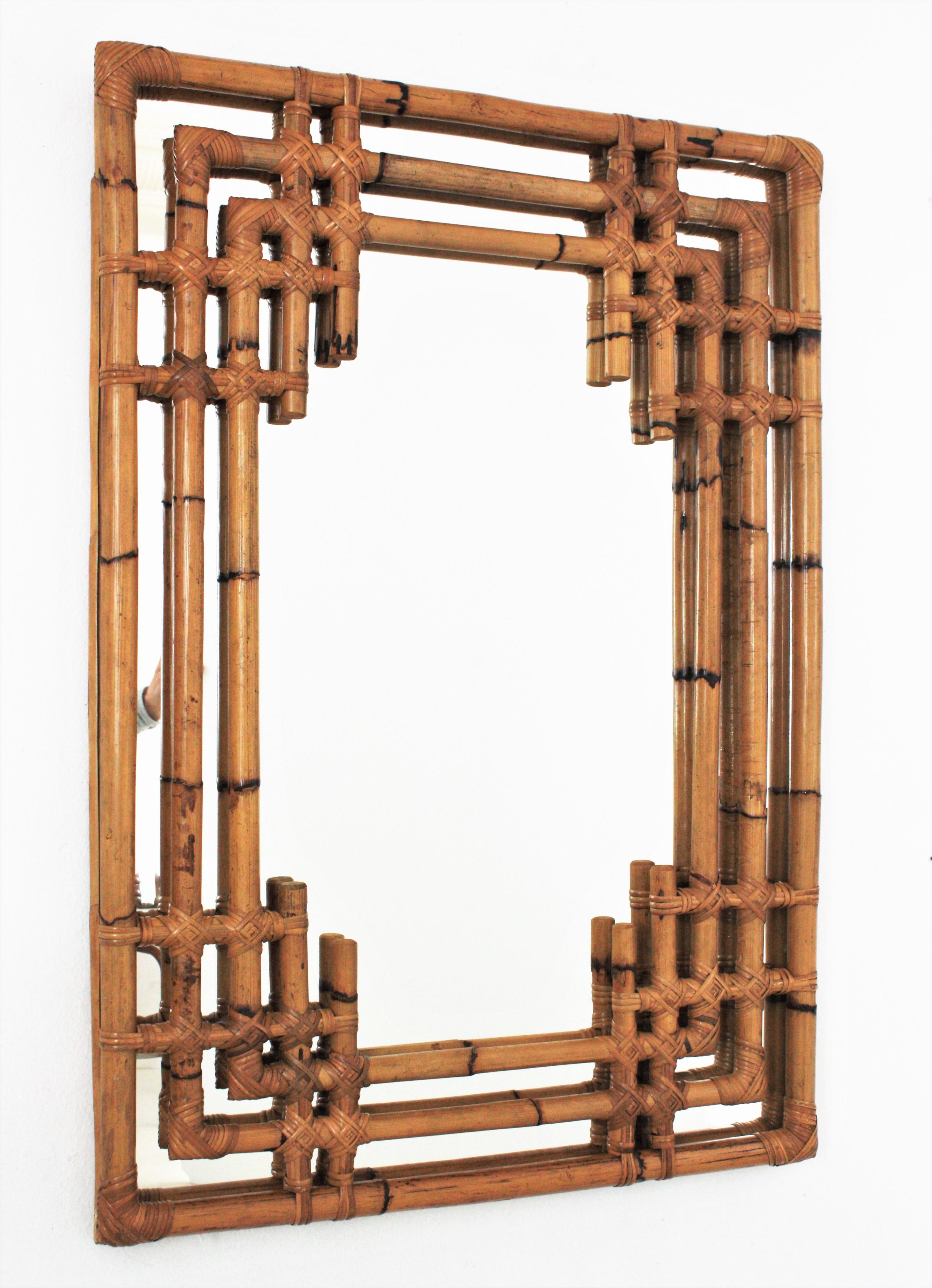 Spanish Mid-Century Modern Bamboo Chinoiserie Tiki style rectangular wall mirror. Spain, 1960s.
Gorgeous Tiki style rectangular mirror handcrafted with bamboo canes. It has a highly decorative frame with oriental inspired geometric decorations and a